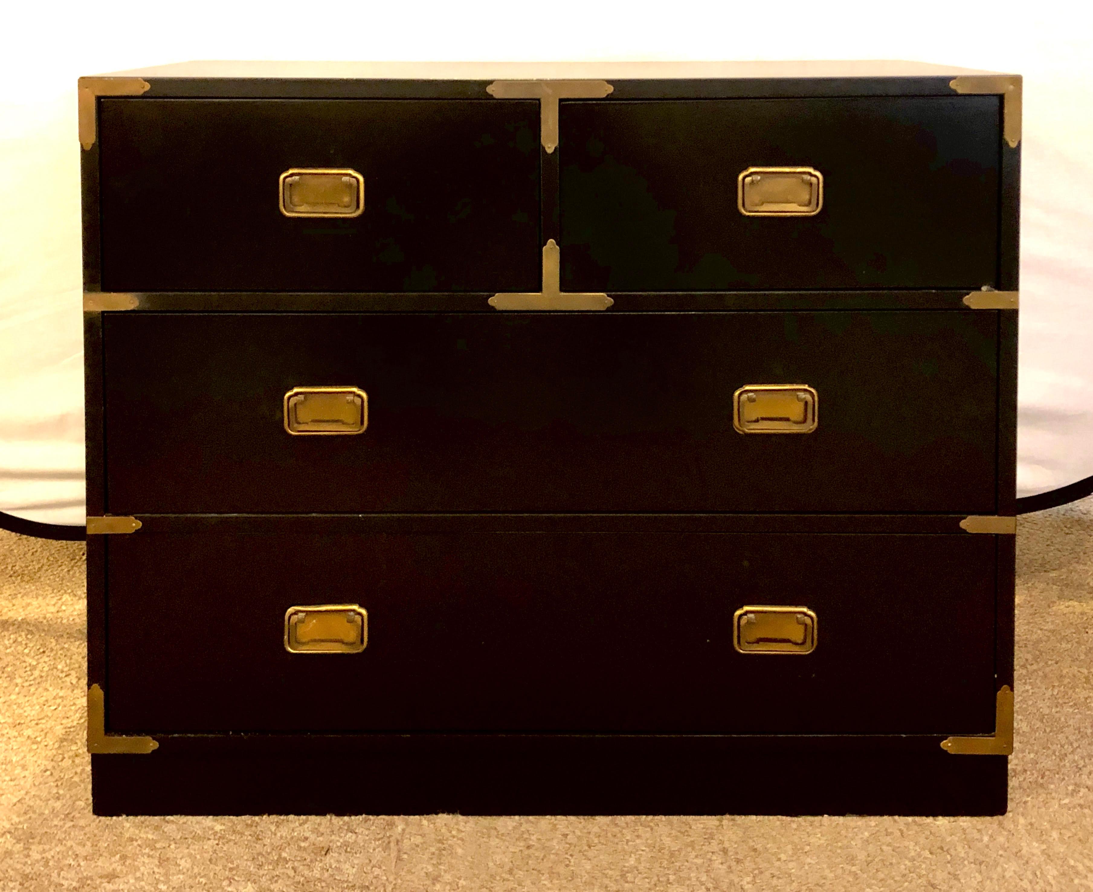 Campaign style ebony chest / dresser by Baker. A sleek and finely painted two over two campaign chest of drawers or nightstand.