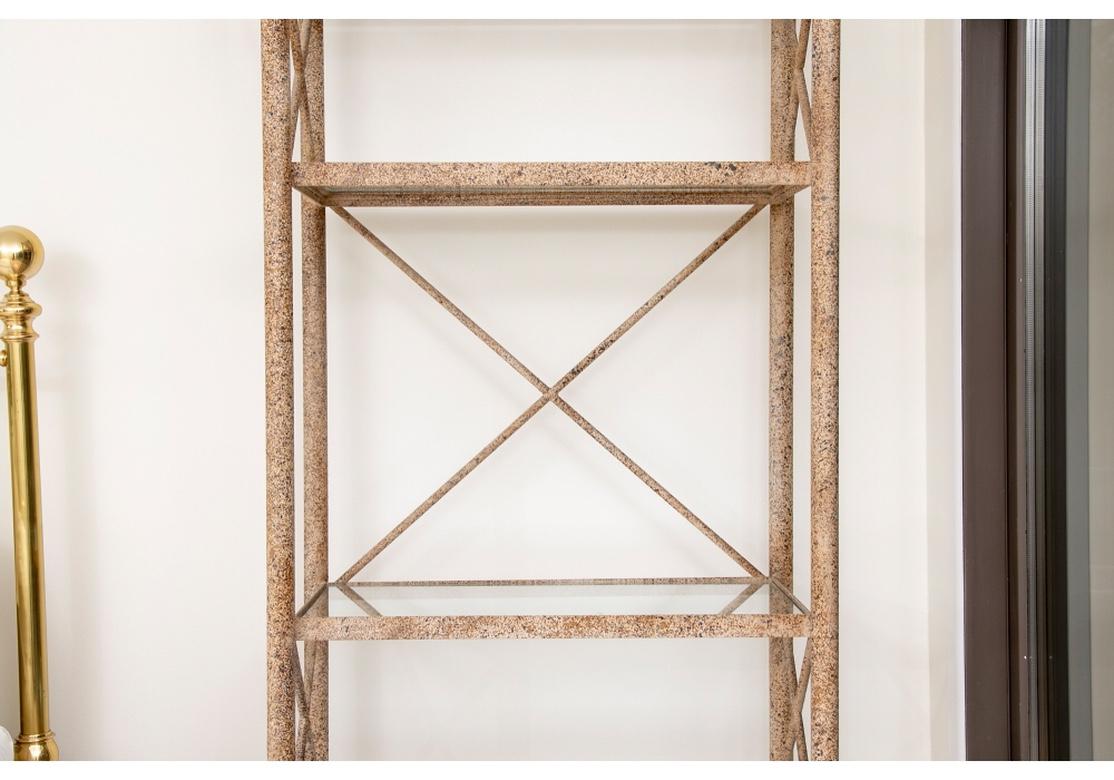 A large and decorative steel frame open four shelf étagère with X-form side and back braces having glass shelves. The painted finish is textured and a very fine application, the color a speckled neutral stone like finish. The étagère has good