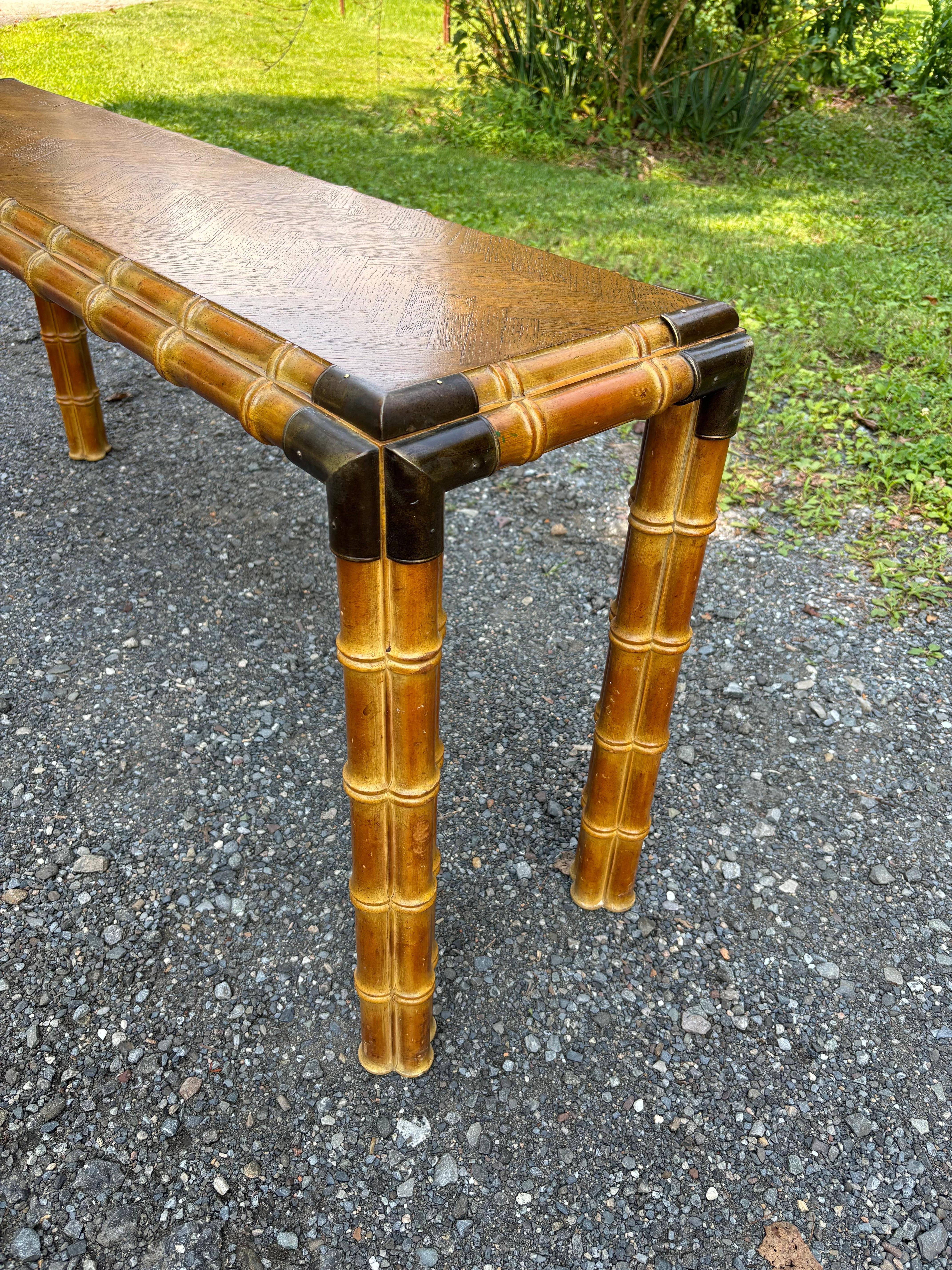 Campaign Style Faux Bamboo Console or Sofa Table.  Oak Parquet Top with faux bamboo sides and legs.  Brass accent corners complete the campaign style.  Top has been refinished, nice and solid!  Great look that fits into many decors.