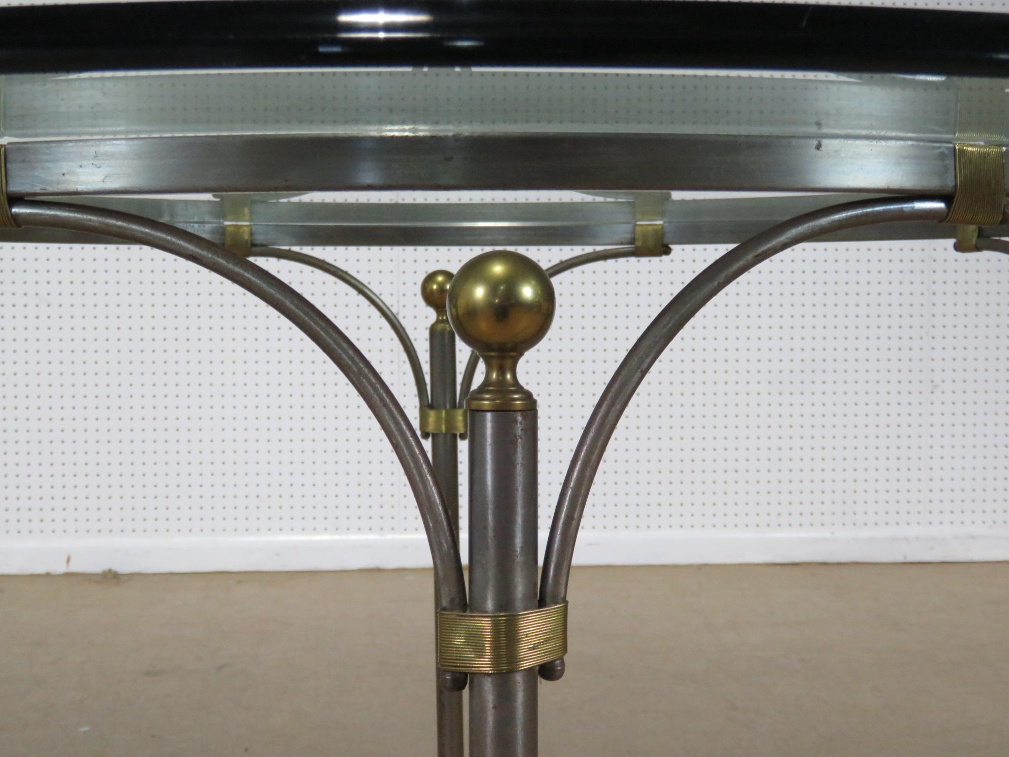 This is a beautiful French Directoire brass and steel center or possibly a small breakfast or dining table. Designed in the style of John Vesey, this table is very sophisticated and yet simple. The craftsmanship is of the best possible quality and