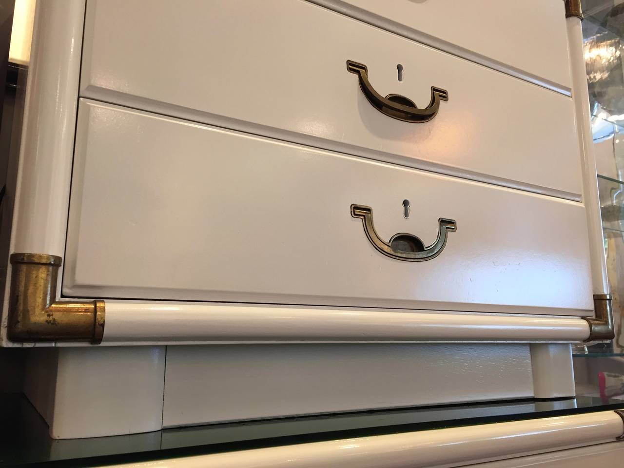 white bedside table and chest of drawers