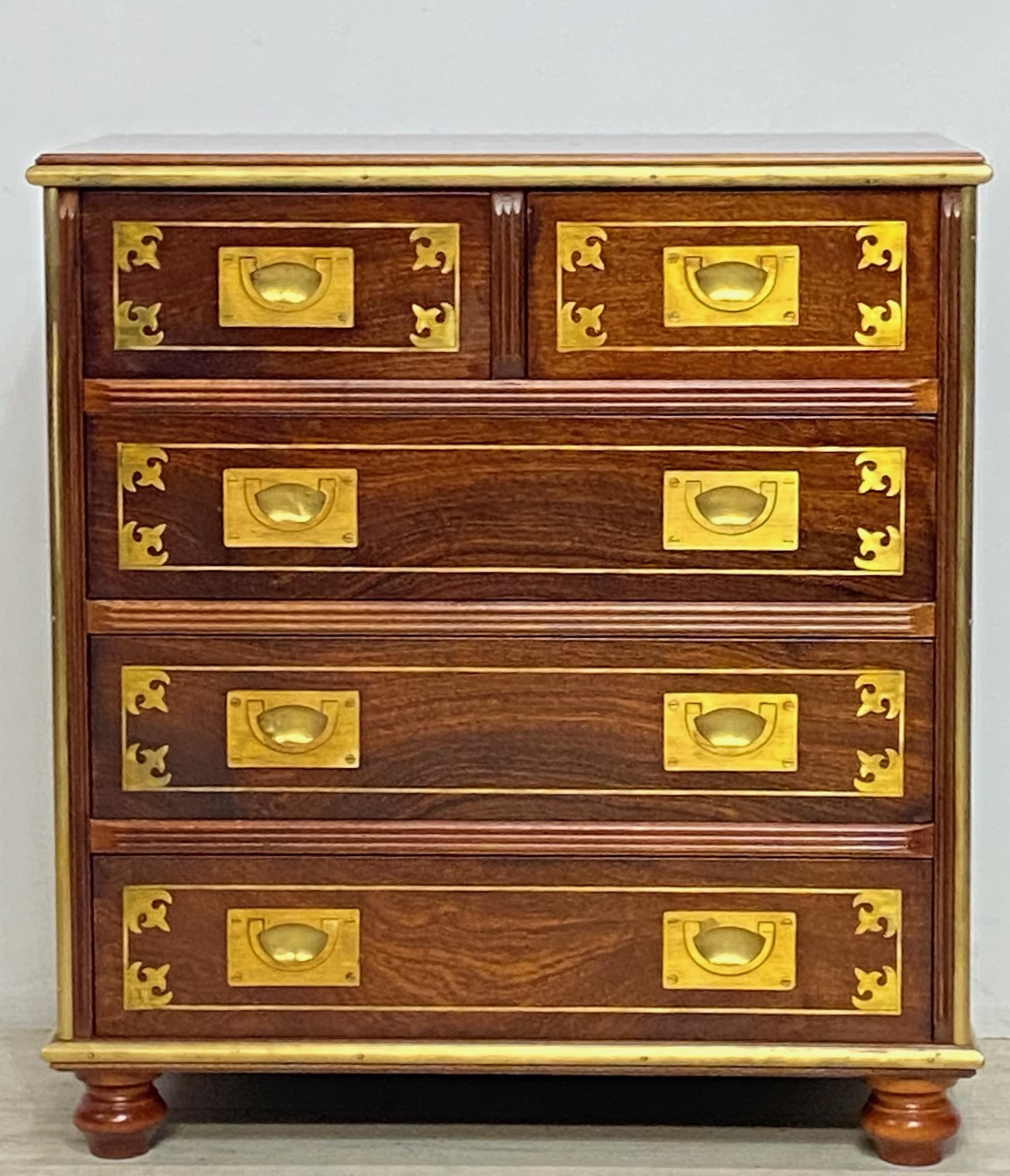 A solid mahogany small chest of drawers with inlaid brass and having inset solid brass hardware and edges. Inset small brass plaque on top reads 'The Clermont'
Part of the 