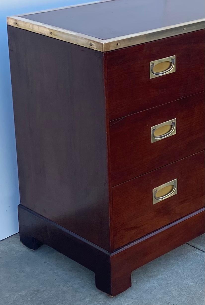 This is a 1950s campaign style mahogany credenza attributed to Kipp Stewart for Directional. It’s unusually long size along with the polished brass trim and hardware give the piece a more modern feel. There are three additional drawers behind the