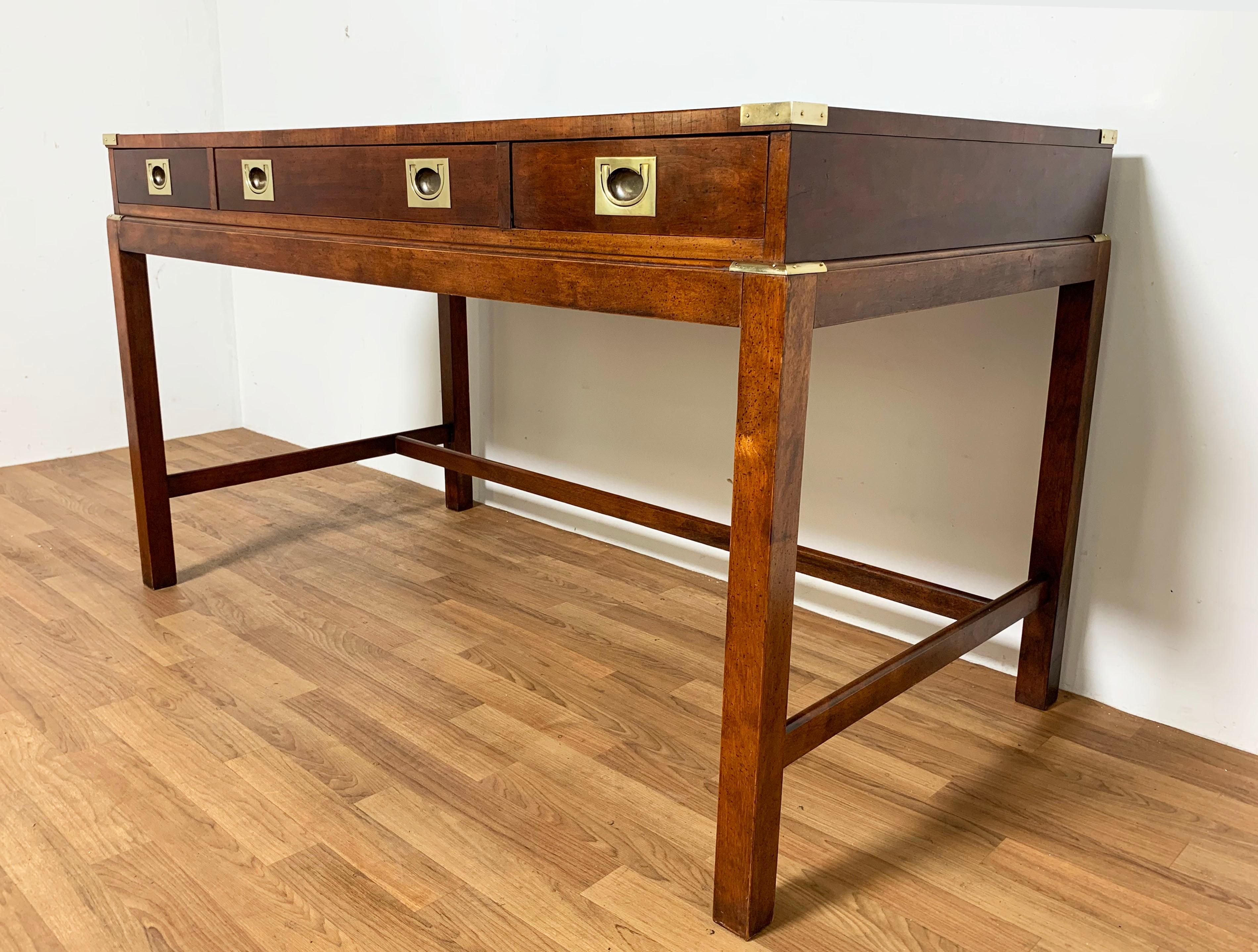 A campaign style writing desk in mahogany with brass hardware, circa 1970s.