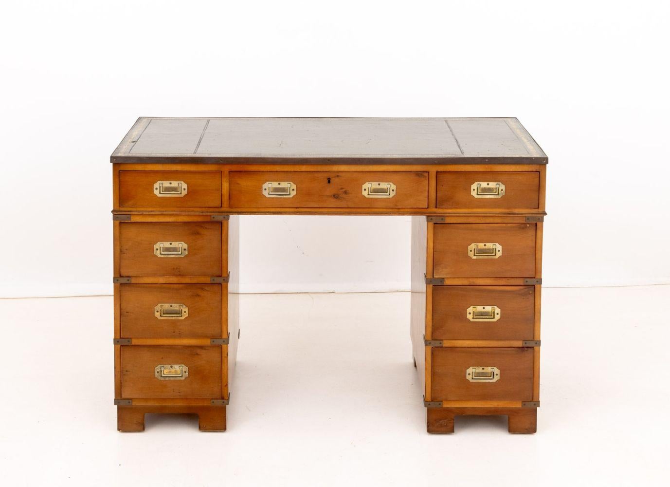 Campaign Style Maple Writing Desk, with gilt-tooled green leather top above three drawers upon two supports with three drawers each. 31.25 H x 27 W x 23