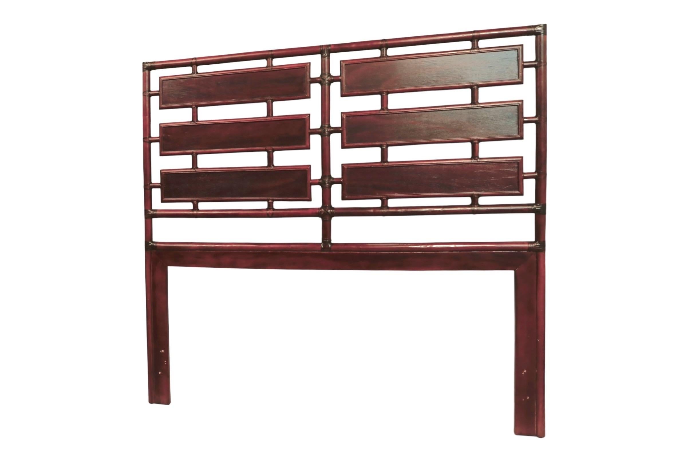 A campaign style queen headboard made of bamboo and rattan. A bamboo frame supports six wooden panels, secured with rattan wrapping at the joins.