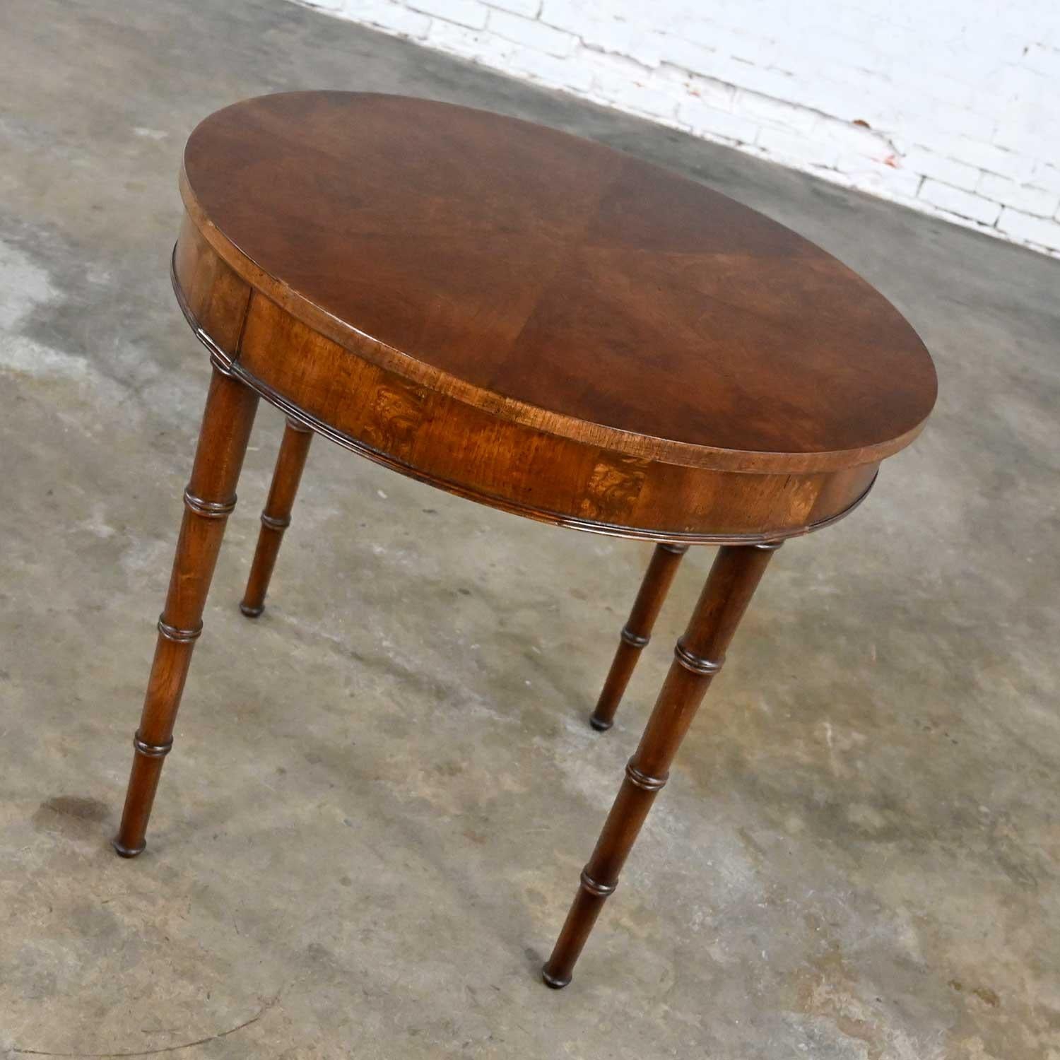 Fabulous vintage campaign style round Walton accent or lamp table with inlayed walnut veneer & faux bamboo legs by Fine Arts Furniture Co. Beautiful condition, keeping in mind that this is vintage and not new so will have signs of use and wear. The