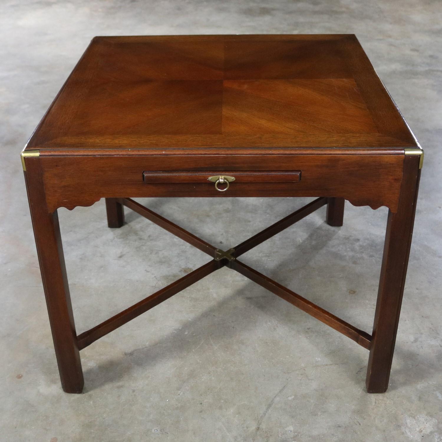 Handsome vintage mahogany Campaign style square side table or end table with a pull-out shelf or tray and beautiful brass accents. This table is in excellent vintage condition, circa midcentury to late 20th century.

This exceptionally beautiful