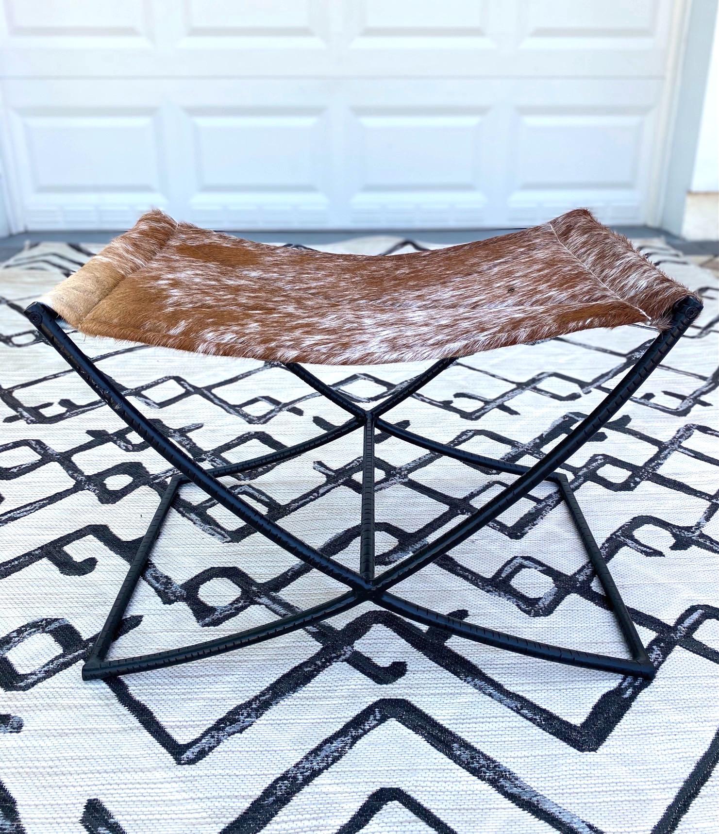 Indonesian Campaign Style Stool with Brown and White Cowhide Seat and Black Iron Base
