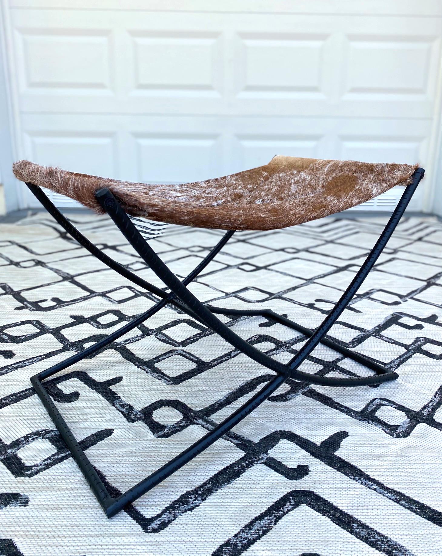 Hand-Crafted Campaign Style Stool with Brown and White Cowhide Seat and Black Iron Base