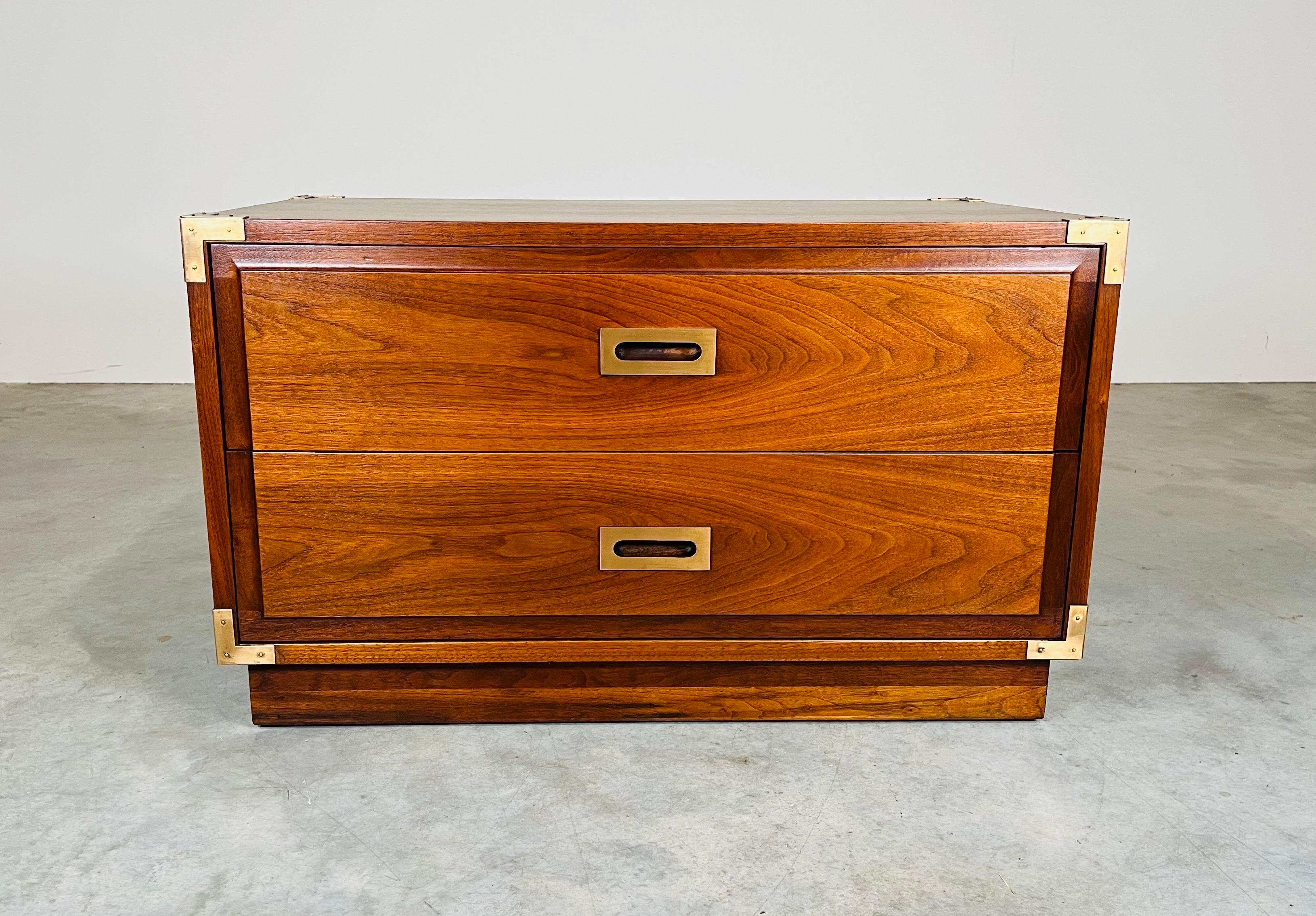 Handsome 2-drawer Campaign Style chest having solid walnut construction with brass pulls, side handles and corner accents. Incredible craftsmanship throughout with great detail and stunning walnut grain. Finished on all sides. 
In excellent
