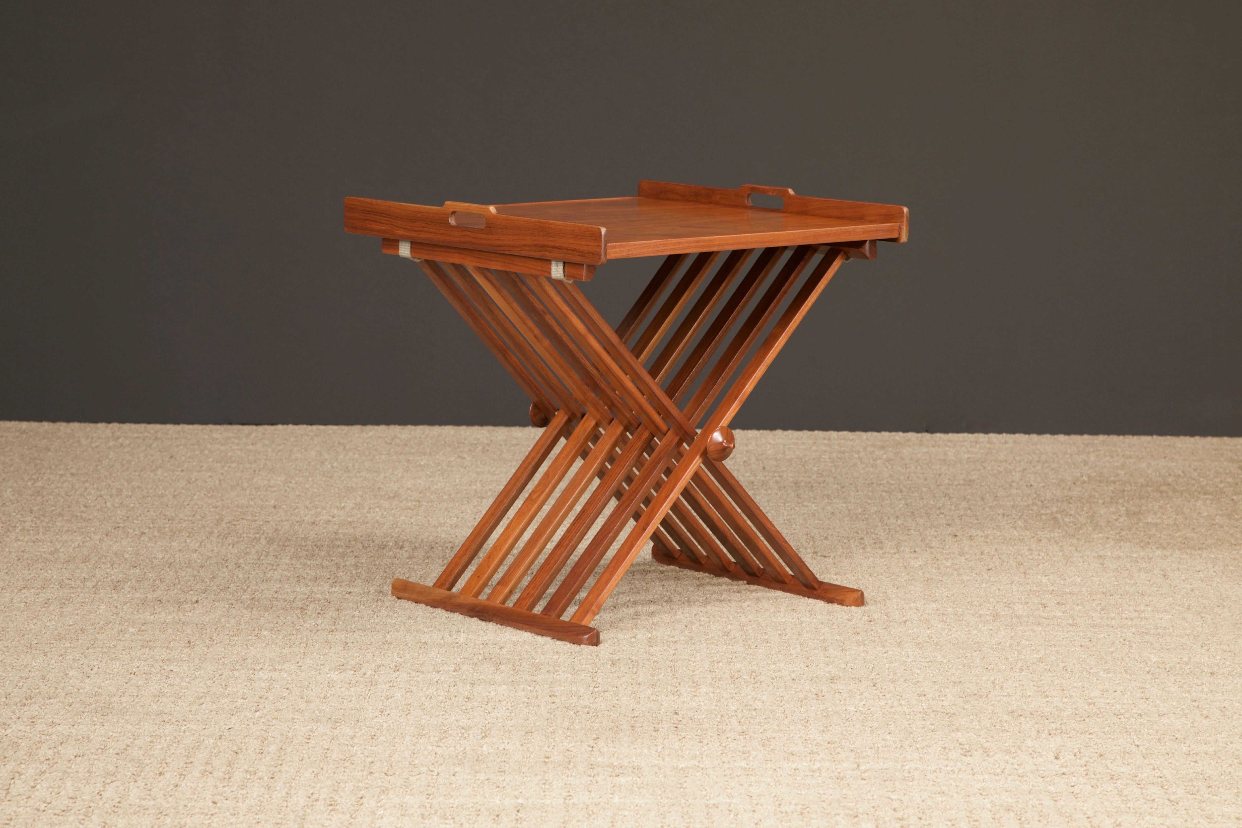 Renowned designers Stewart MacDougall and Kipp Stewart created the folding campaign tray table for Drexel Furniture Company in the 1960s as part of the 'Declaration' line of furniture. Constructed in walnut, with a removable tray top and a folding