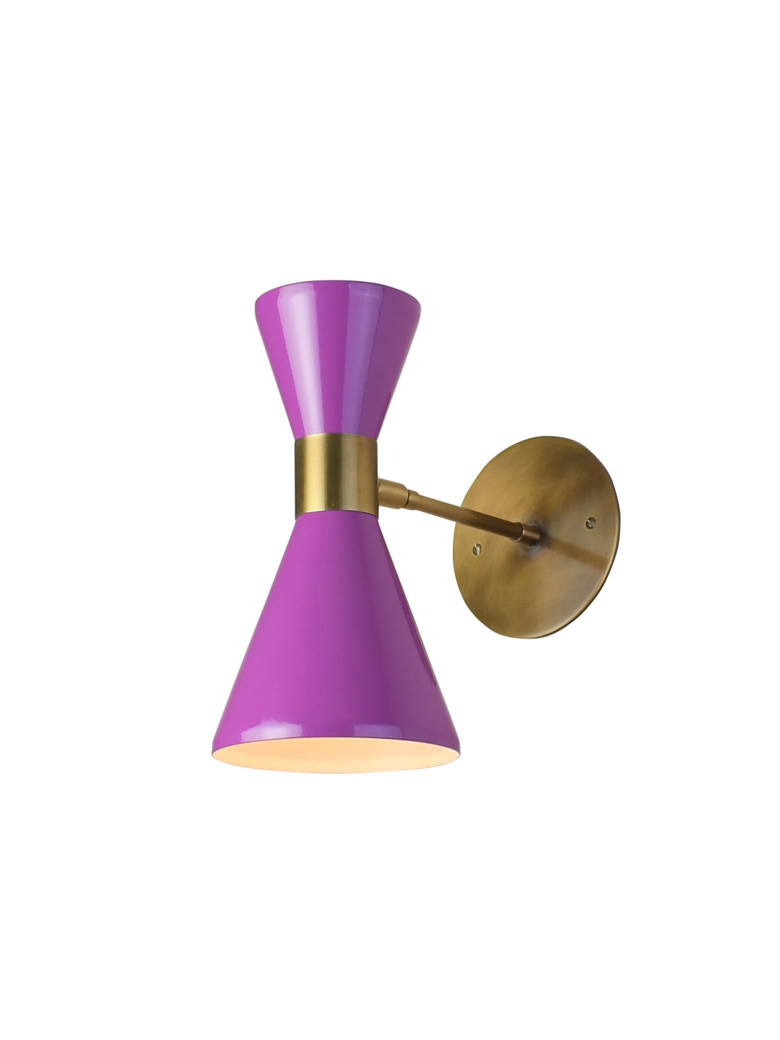 The Campana wall sconce or reading light shown in brushed brass and violet enamel by Blueprint Lighting, 2018. The wide band and distinctly bevelled edge makes the Campana a strong design statement. Swiveling head allows for cone adjustment. The