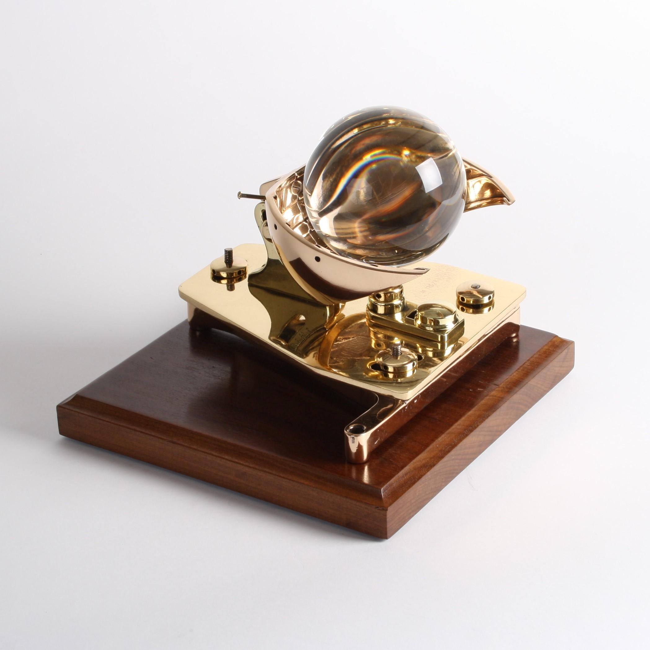 A campbell–stokes sunshine recorder by Casella of London.

Dated 1944. 

Marked with the Casella logo and M 176/44

The Campbell–Stokes sphere is used to record sunshine.

On a later hardwood display board 10 x 9 3/4 inches.

It was