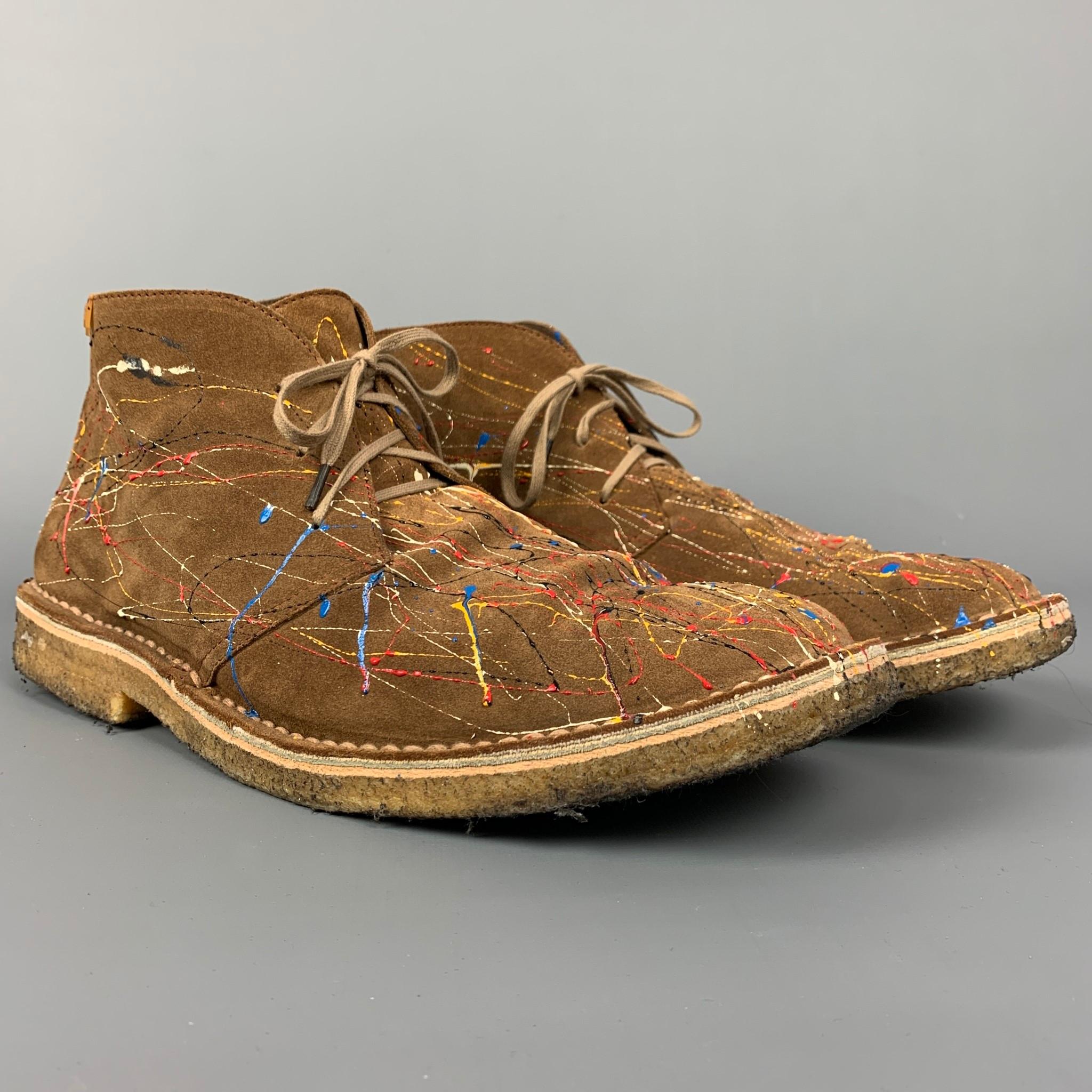 Las botas CAMPER se presentan en ante marrón con un diseño de salpicaduras de pintura multicolor, estilo chukka, suela de crepé y cierre de cordones. 

Buen estado usado.
Marcado: 45

Medidas:

Longitud: 12.5 pulg.
Anchura: 4,5 pulg.
Altura: 5 pulg. 