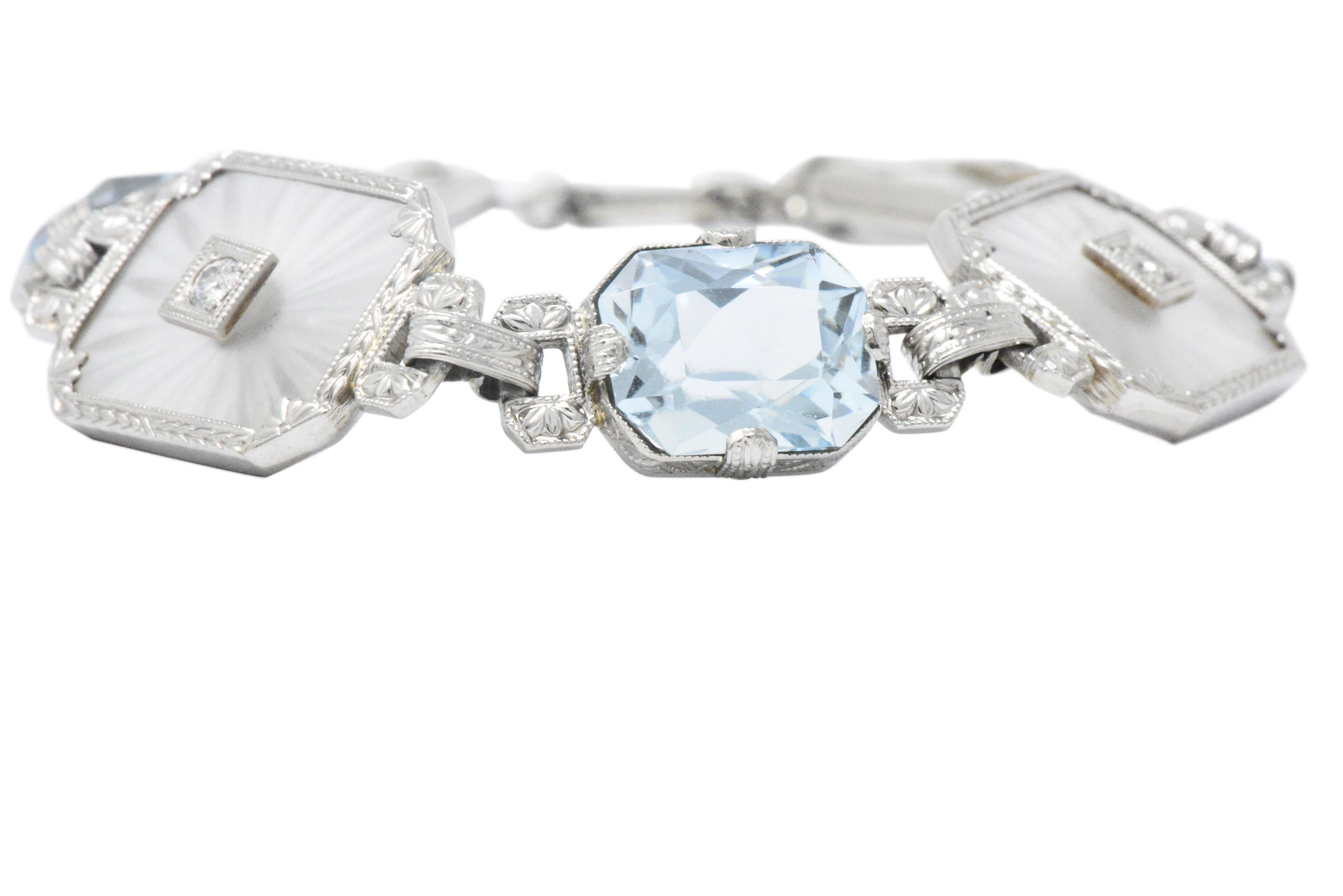With three cut-corner, rectangular brilliant cut aquamarines, weighing approximately 10.50 carats total, bright light blue, very well matched, bezel set

Four camphor glass links, each centering an old European cut diamond, approximately 0.28 carats