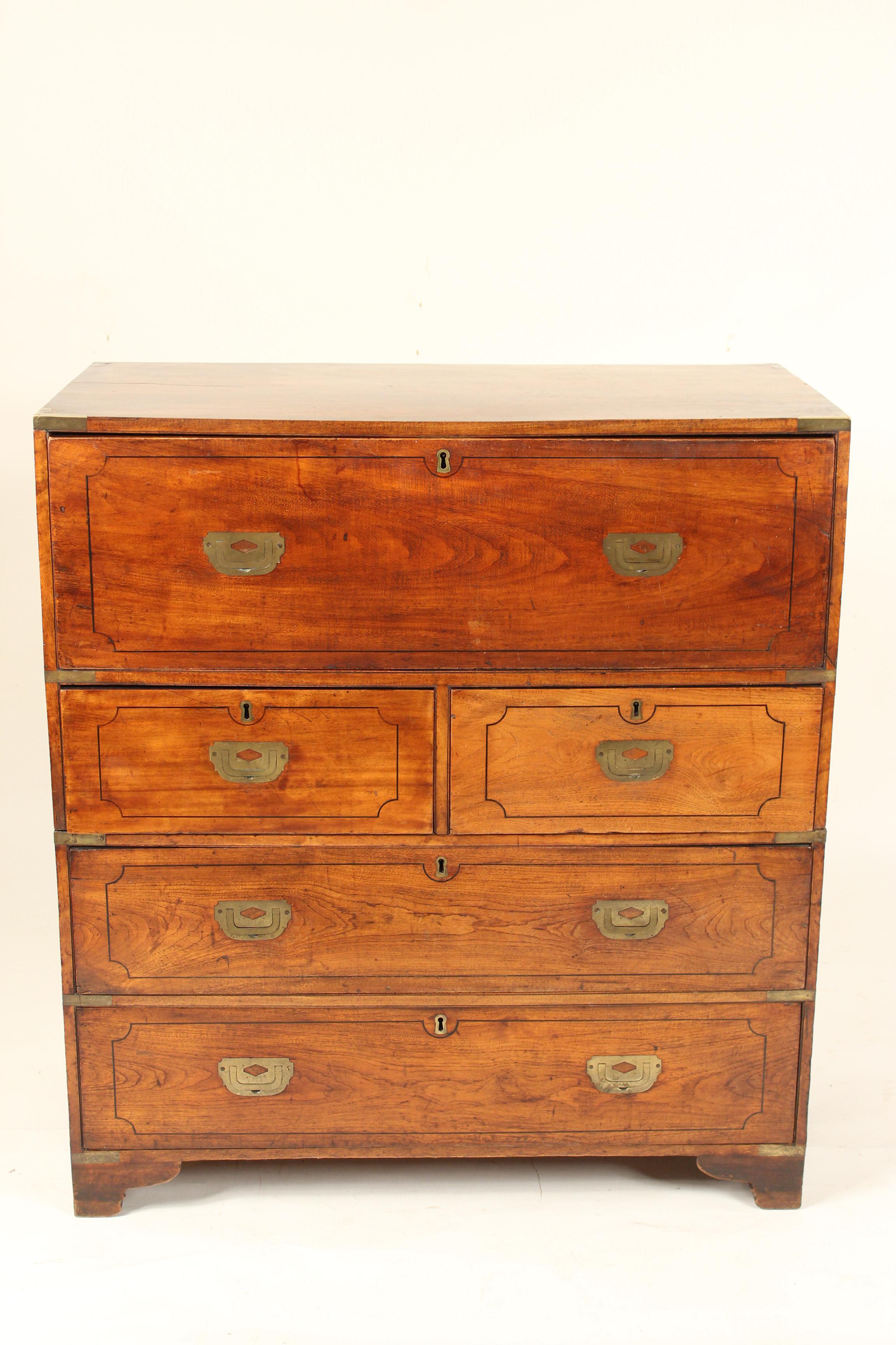 Camphor wood Campaign desk / chest with brass Campaign hardware, late 19th century. The top drawer folds down into a leather top writing surface. This desk / chest has excellent old color and original brass hardware. This is a two part chest. Most