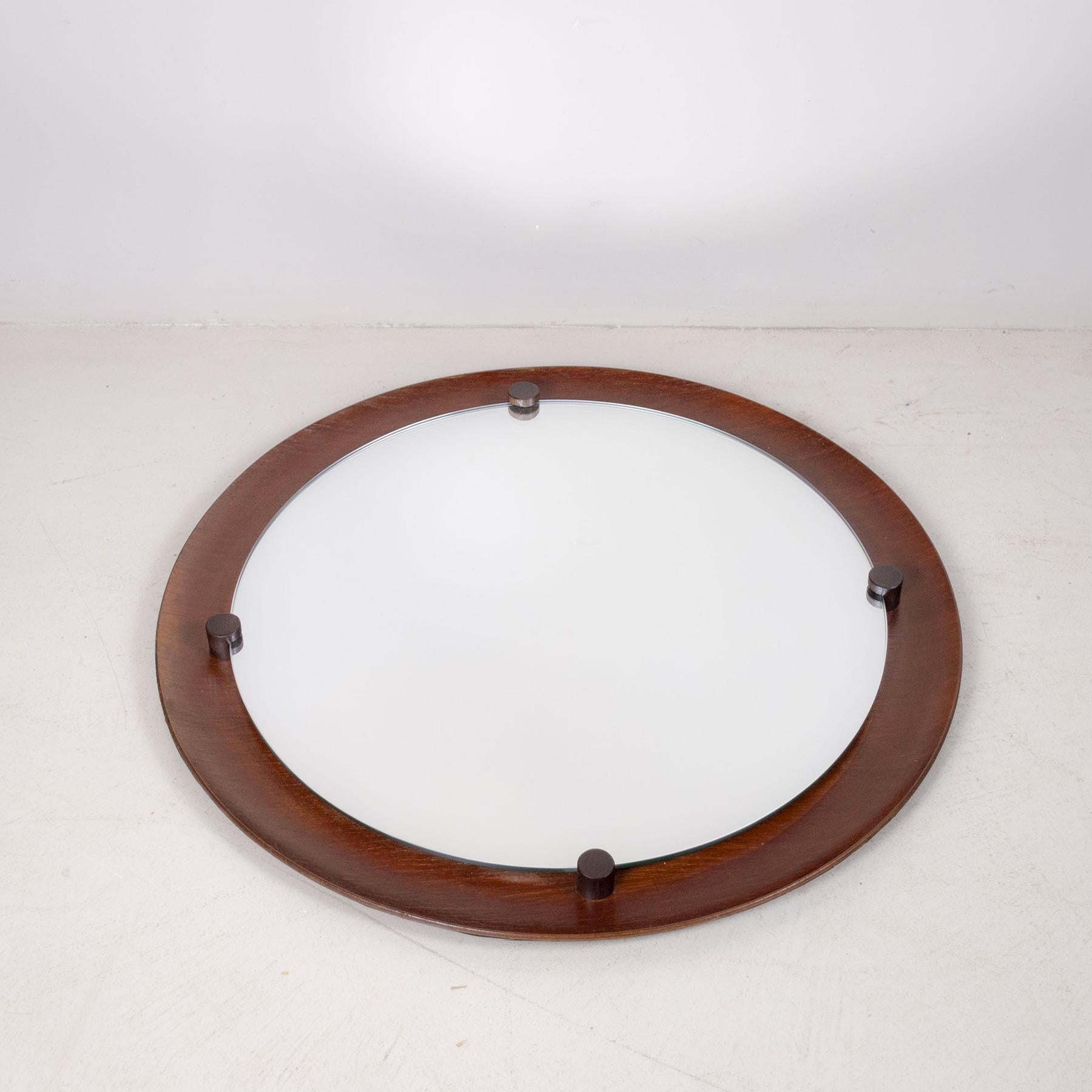 Round teak wood wall mirror design Campo & Graffi Italy 60’s.
Much of Carlo Graffi's professional career is linked to that of Franco Campo; they met as undergraduates at the Turin Polytechnic. They both studied engineering and architecture with