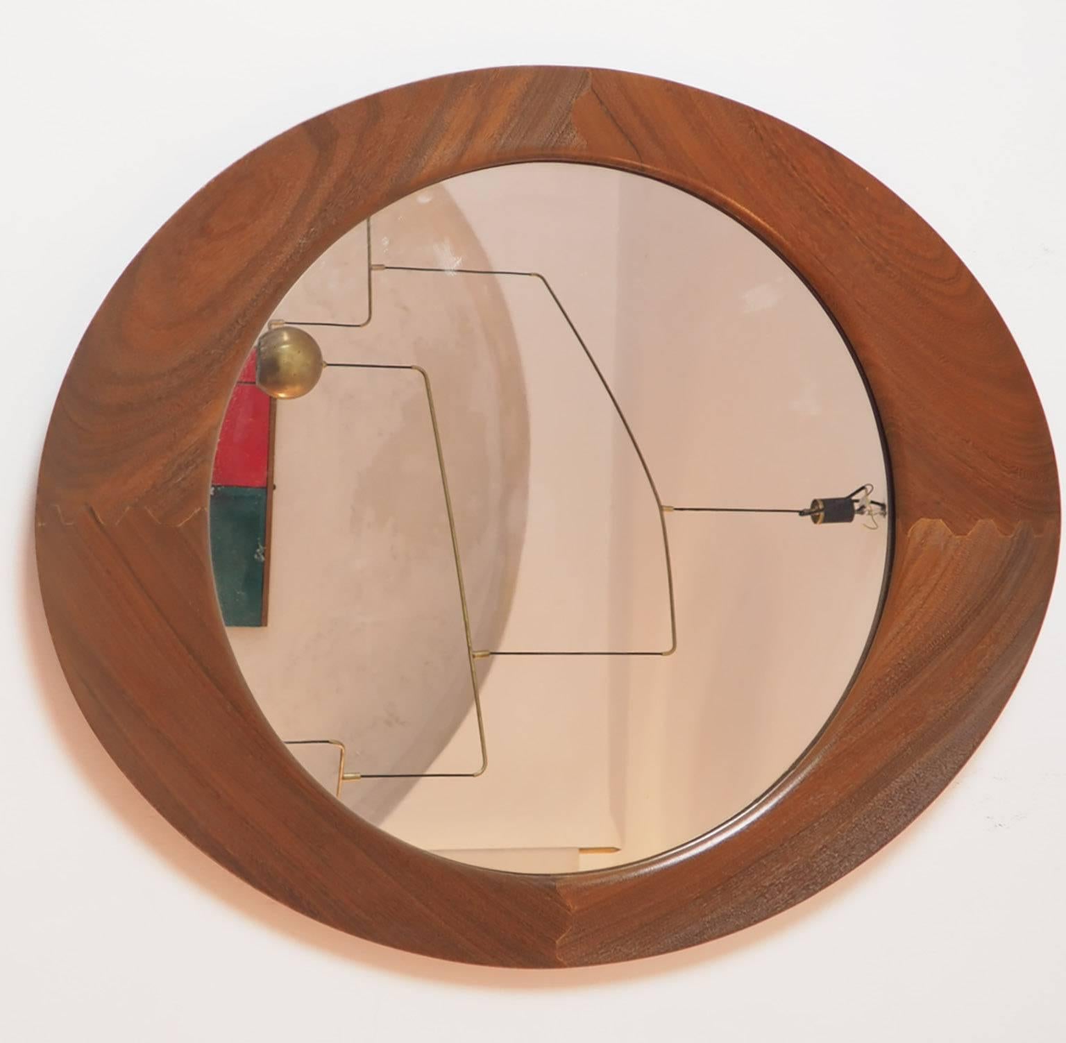 Beautiful and rare mirror designed by Franco Campo and Carlo Graffi for Home in the 1950s
Oval large teak massive frame, with round mirrored glass.
The wood frame has different thickness in the apical width;
Is beautiful both in the vertical or