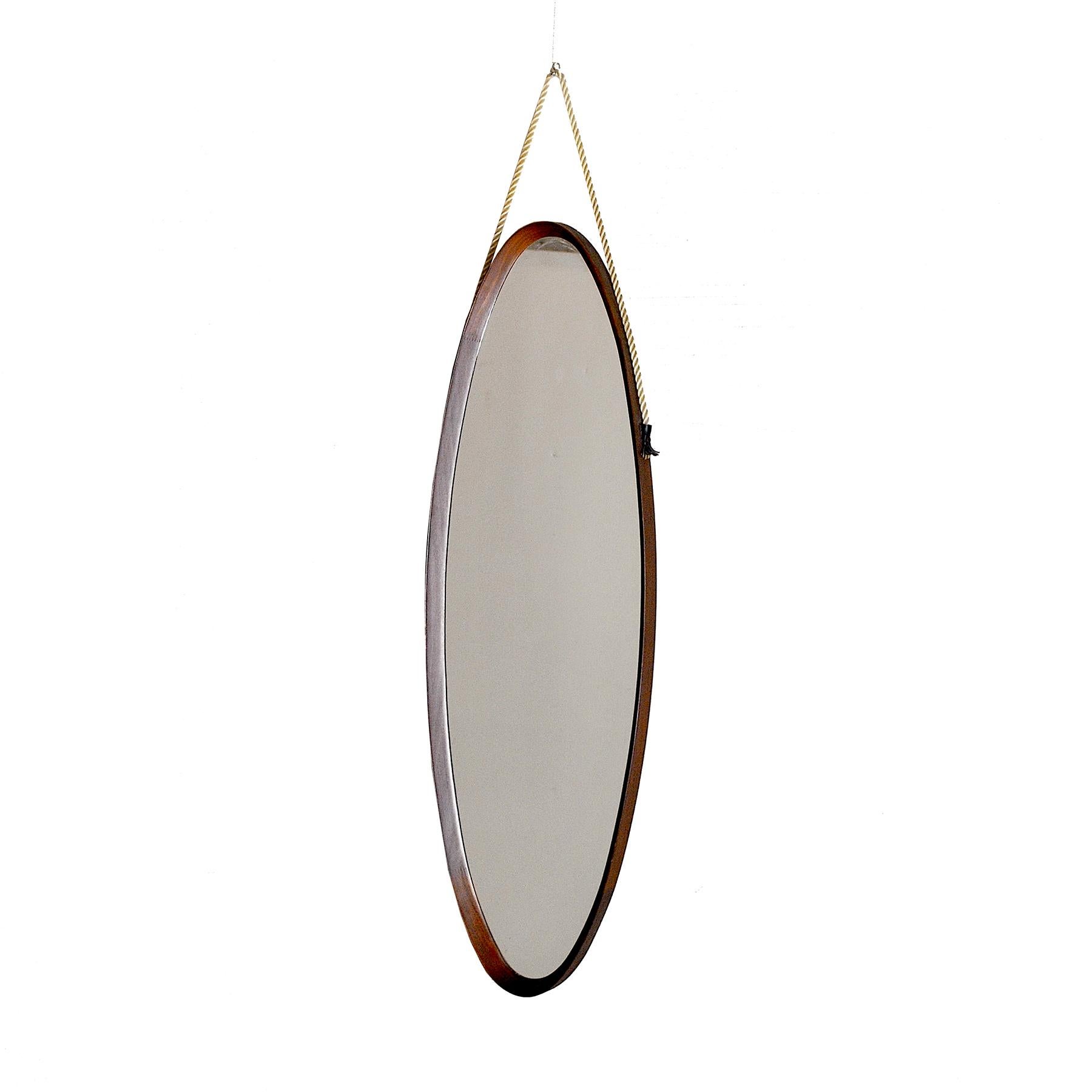 Curved wood mirror, 1960s production, in the Campo and Graffi style.