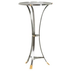 “Canabas” pedestal table in patinated leather, steel, and gilded brass.