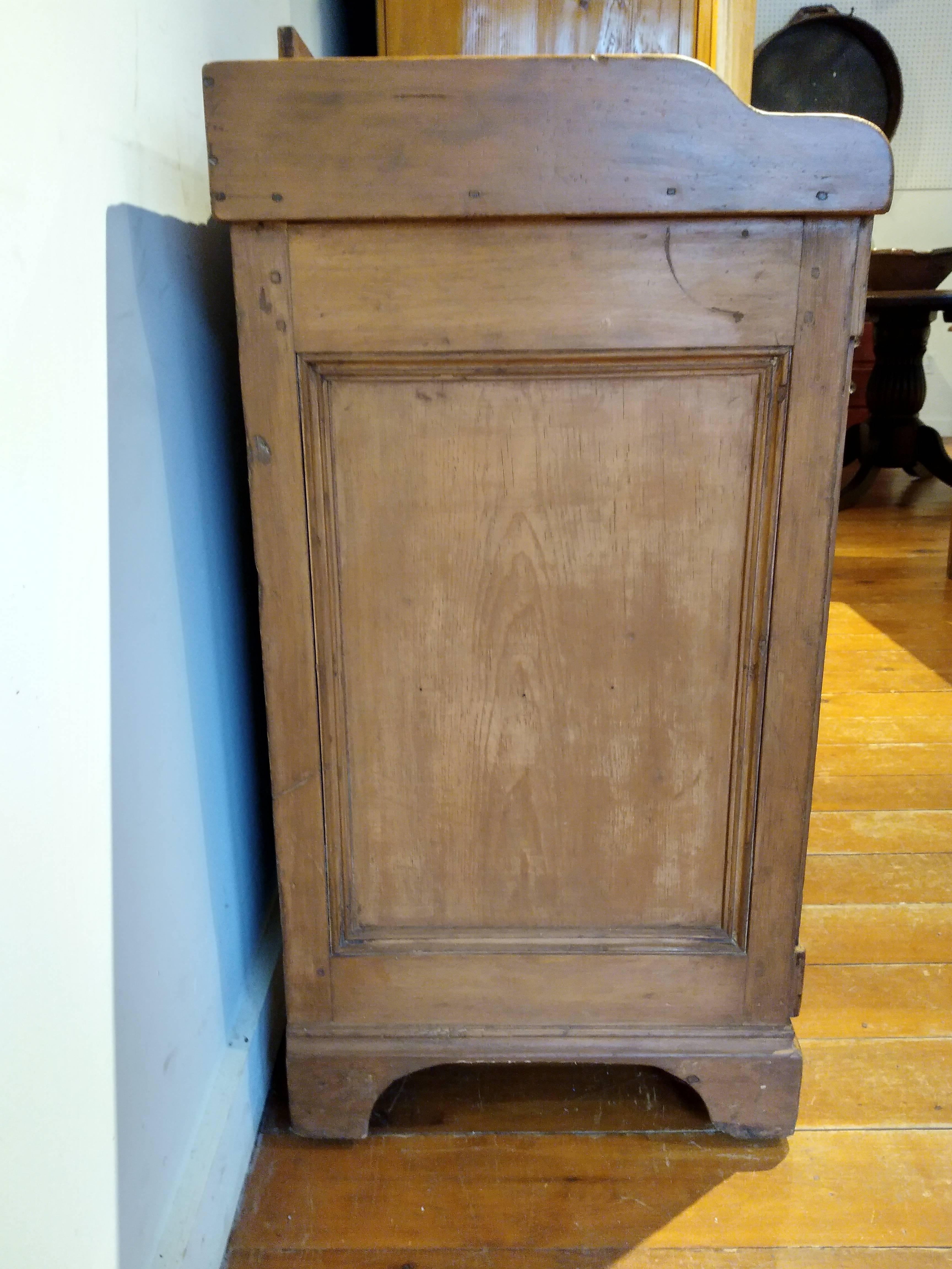 Pine, 1890. This is a sweet piece with lots of character wrapped up in the doors and drawers with original hardware. If that weren't enough there is a railing around three sides of this piece that lend an extra special touch.