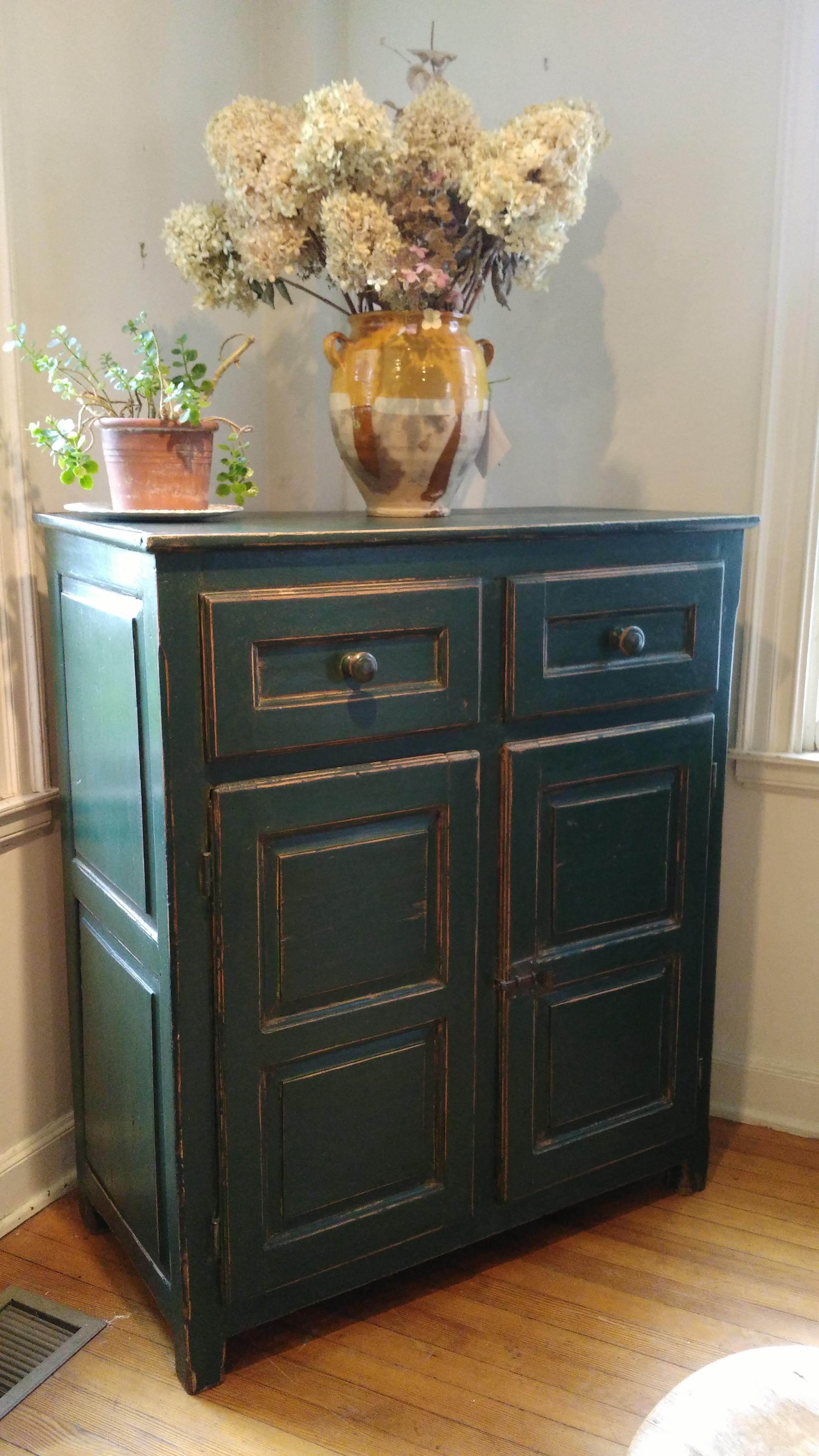 Let's start with the color of this piece: A rich green with paneled sides and front. There is a shelf inside the pine double doors, and a wonderful latch. Add in the two large drawers and you've got a very special Canadian buffet!
   