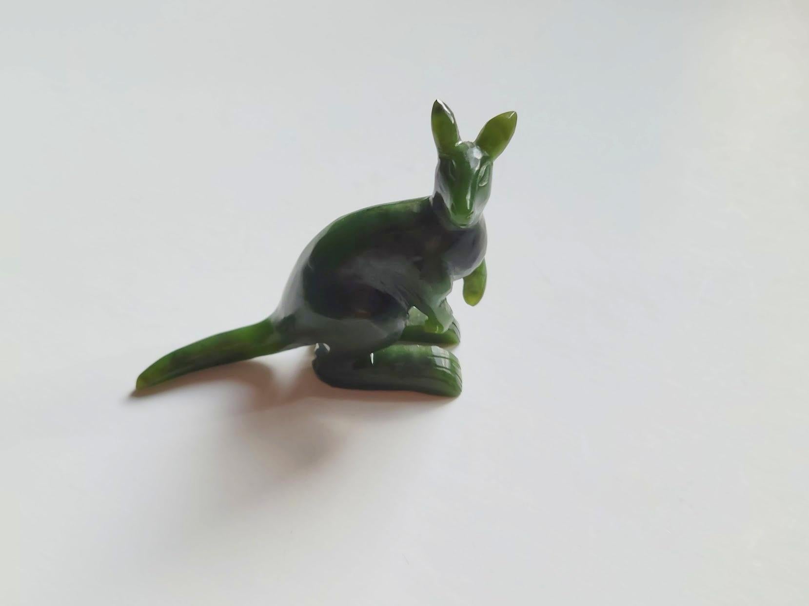 Zu allen Zeiten waren Miniatur-Tierfiguren aus Halbedelsteinen sehr beliebte Geschenke. 
Dieses charmante Känguru ist eine atemberaubende Verkörperung exquisiter Handwerkskunst, sorgfältig aus kanadischem Nephrit geschnitzt und makellos poliert.