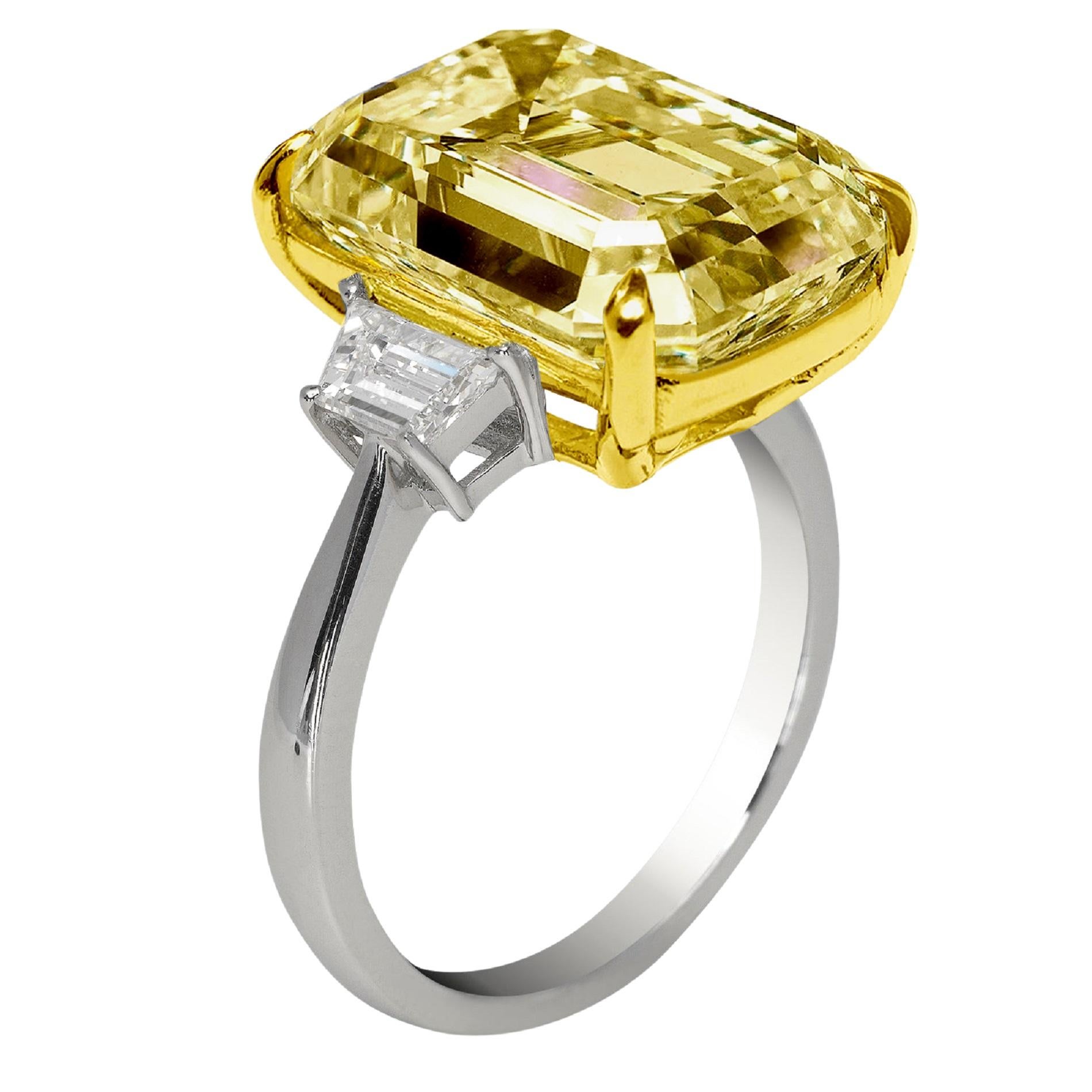 An exquisite 7 carat fancy intense yellow 10 carat emerald cut diamond ring set in platinum and 18 carats yellow gold

the ring has been handmade in Italy with two side tapered baguettes also 100% eye clean and full of brilliance!

the diamond comes