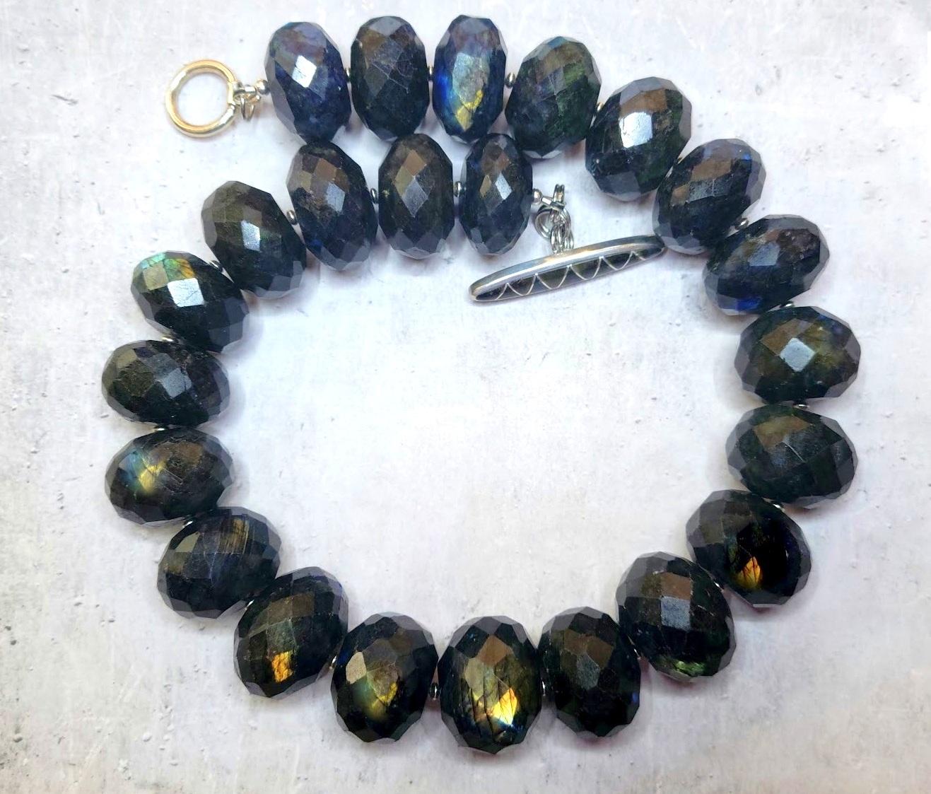 Huge Canadian Labradorite Rondelle Beaded Necklace.

Labradorite is a feldspar mineral.
It has a labradorescence, which is the meaning behind its name. The crystals are often found in thin and tabular shapes with colors ranging from purple to