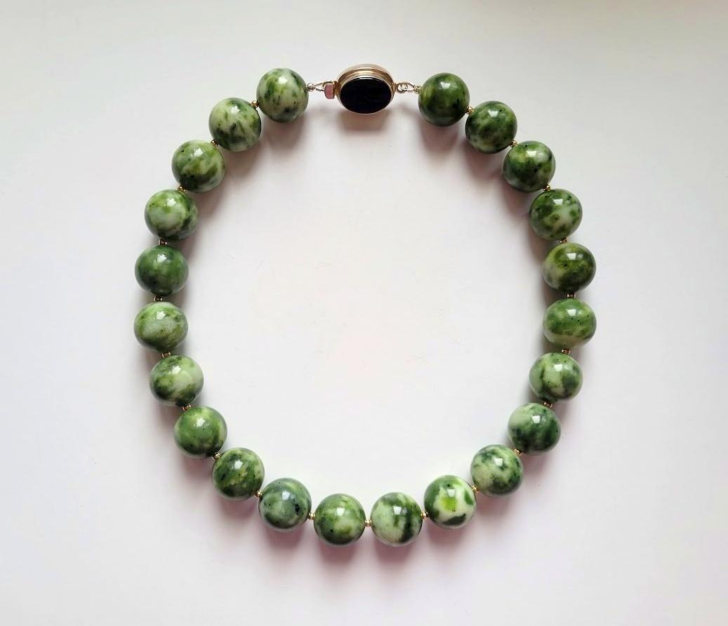 Unusual and rare nephrite from Ogden Mountain in British Columbia.

The length of the necklace is 20 inches (50.8 cm). The size of the smooth round beads is 20mm.
The beads' color is mottled green and white. It's important to note that the color is