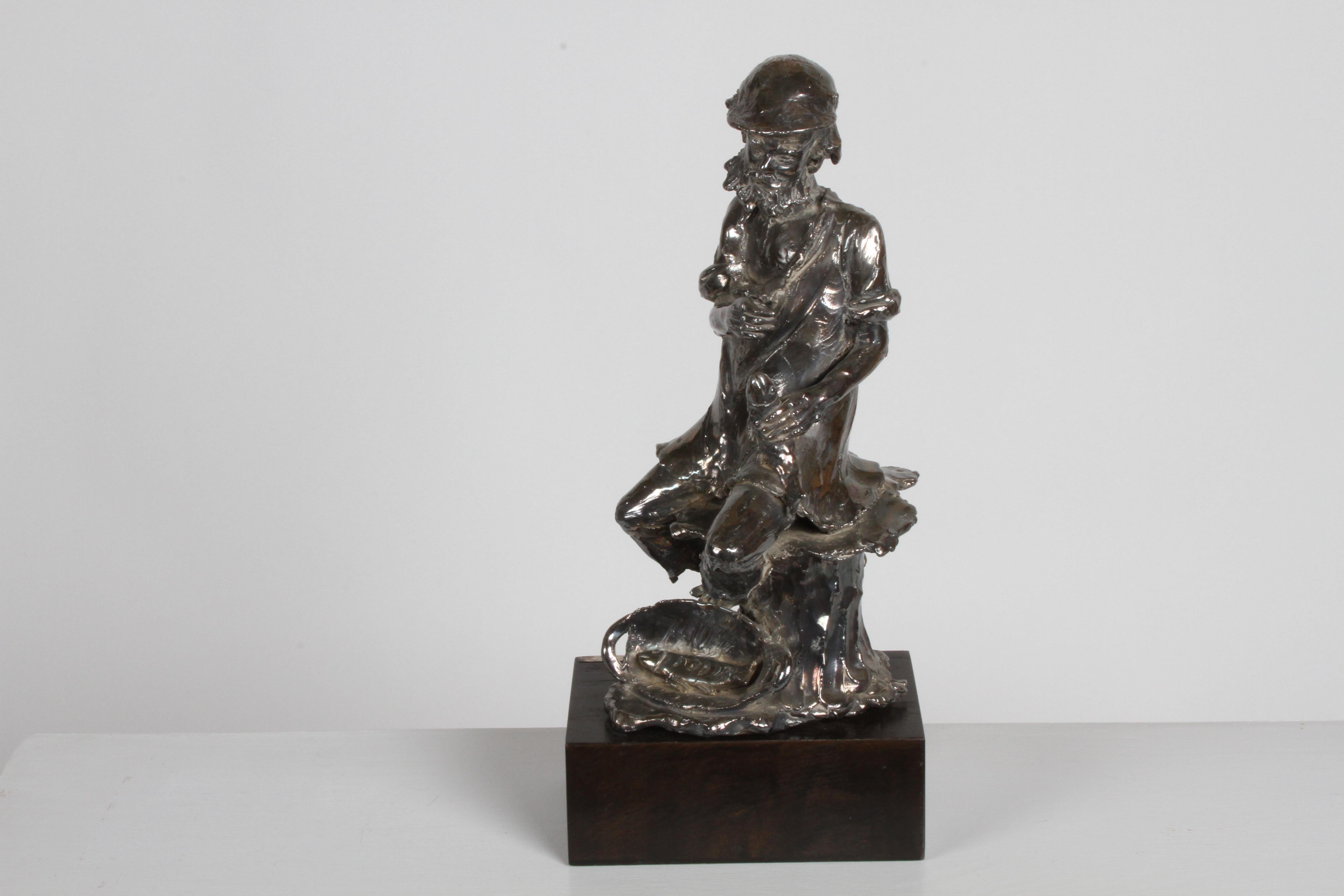 A well-known Canadian sculptor, Alice Winant (nee Czitron) Quebec, Canada/ Romania 1928-1989, unique sterling 925 sculpture of an old bearded fisherman sitting on a stump, holding a fish. Hand signed sterling plaque on wood base A. Winant, back of