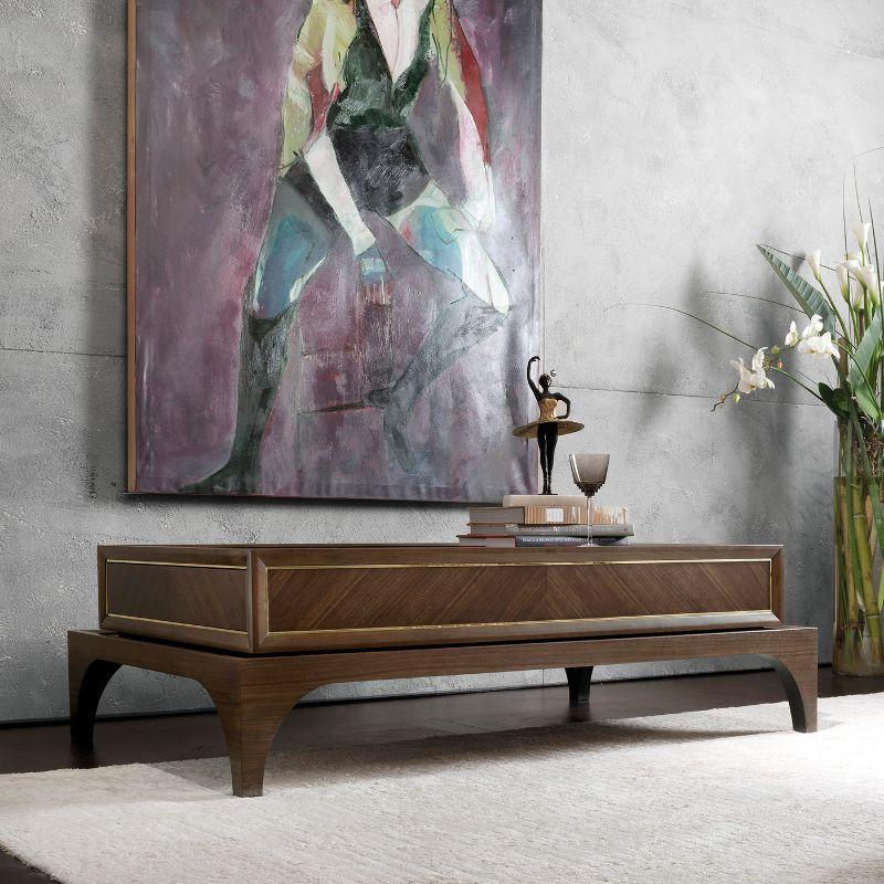 Utterly elegant in its simple, vintage-inspired design, this cocktail table will take center stage in both modern and traditional interiors. It features a Canaletto walnut frame enriched with brass details. Provided with push-pull drawers. Also