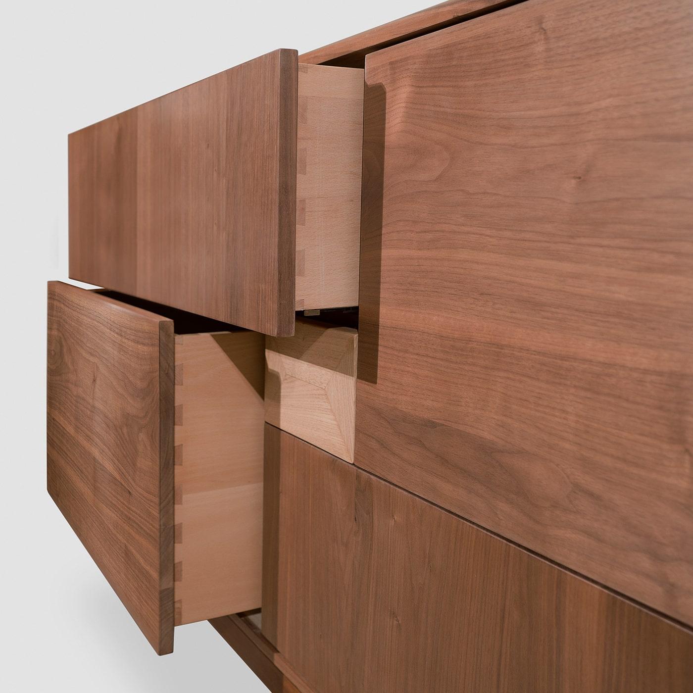 A striking interplay of clean geometric lines, this sideboard will make an elegant statement in a contemporary interior. Handcrafted of Canaletto walnut, it features five drawers placed in an asymmetrical, spiral-like order in different sizes.