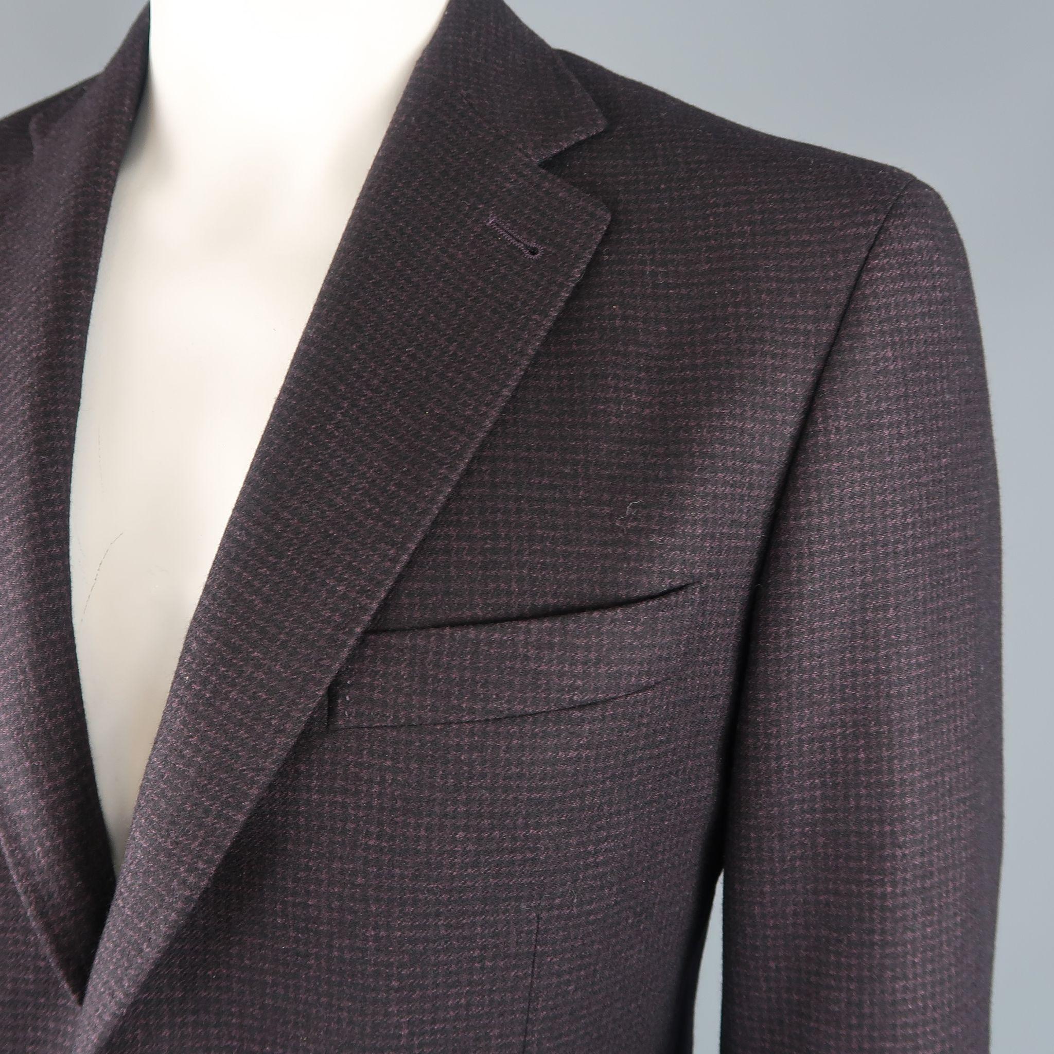 Single breasted CANALI sport coat comes in black and eggplant purple houndstooth print wool cashmere silk blend fabric with a wide notch lapel, two button front, and patch pockets. Made in Italy.

Excellent Pre-Owned Condition.
Marked: 52