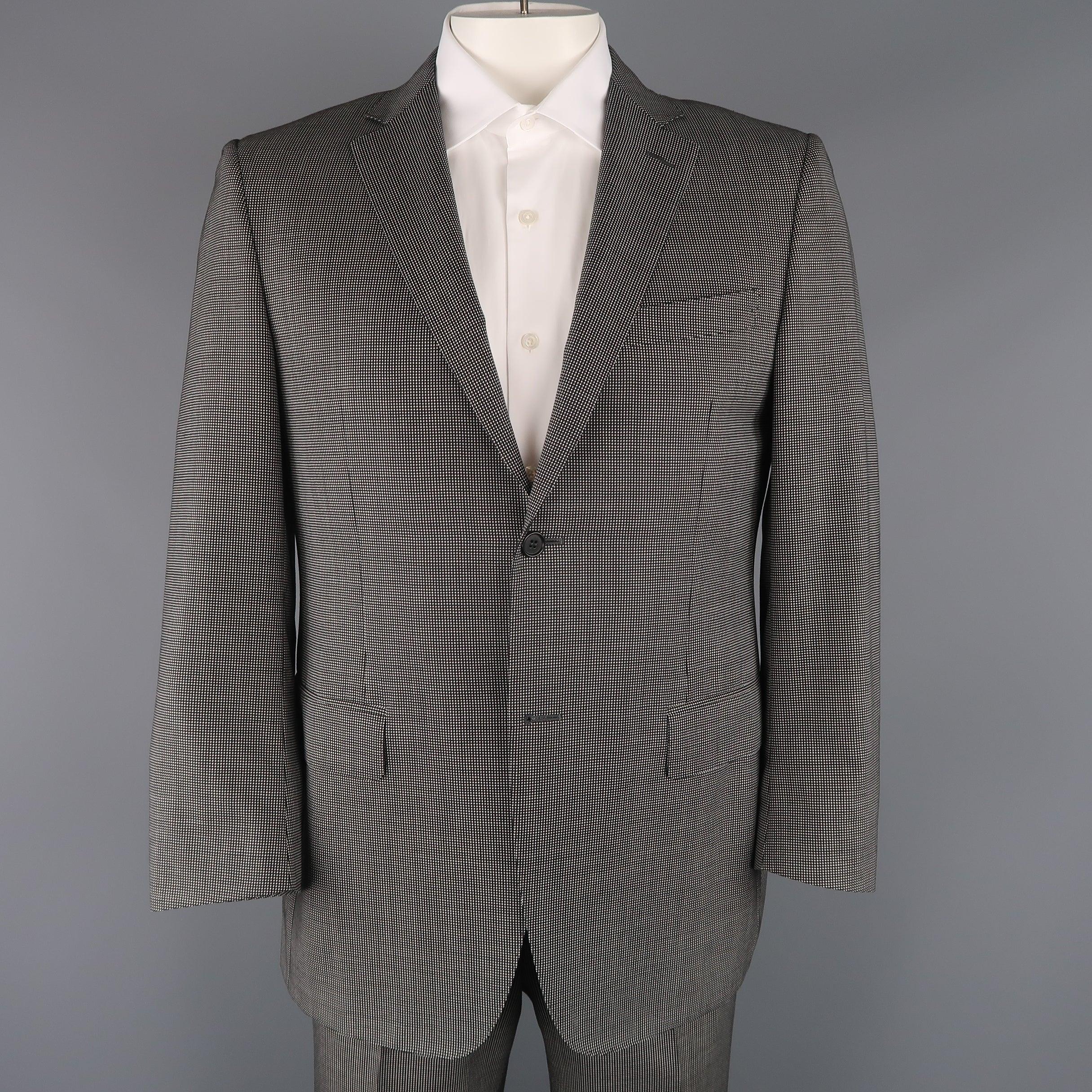 Two piece CANALI suit come sin black and white Nailhead pattern wool and includes a single breasted, two button sport coat with notch lapel, and matching flat front trousers. Made in Italy.Excellent Pre-Owned Condition. 

Marked:   IT 52
