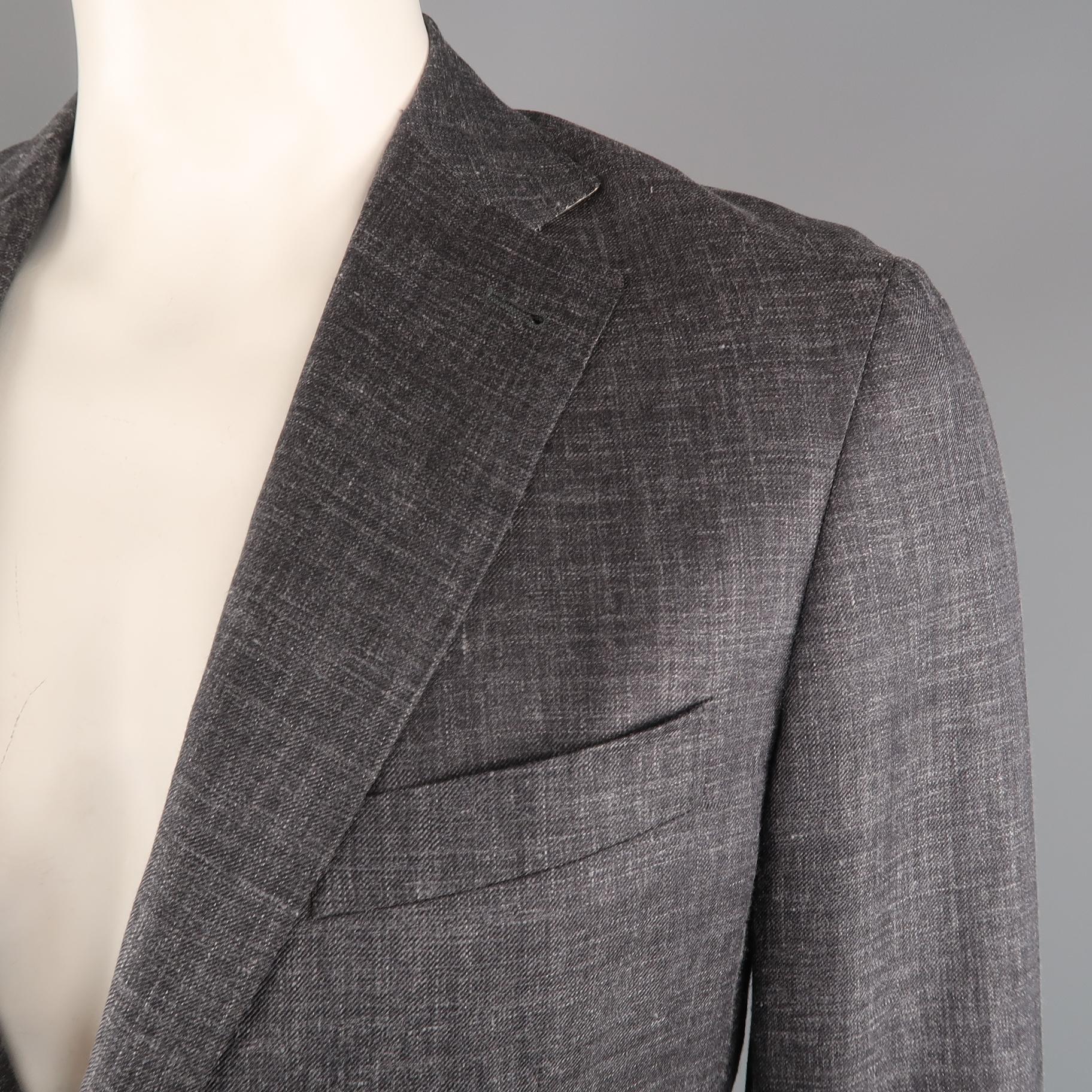 Single breasted CANALI sport coat jacket comes in a dark heather gray textured wool, silk, linen blend material with a wide notch lapel, two button front, and patch pockets. Made in Italy.
 
Excellent Pre-Owned Condition.
Marked: IT 52
