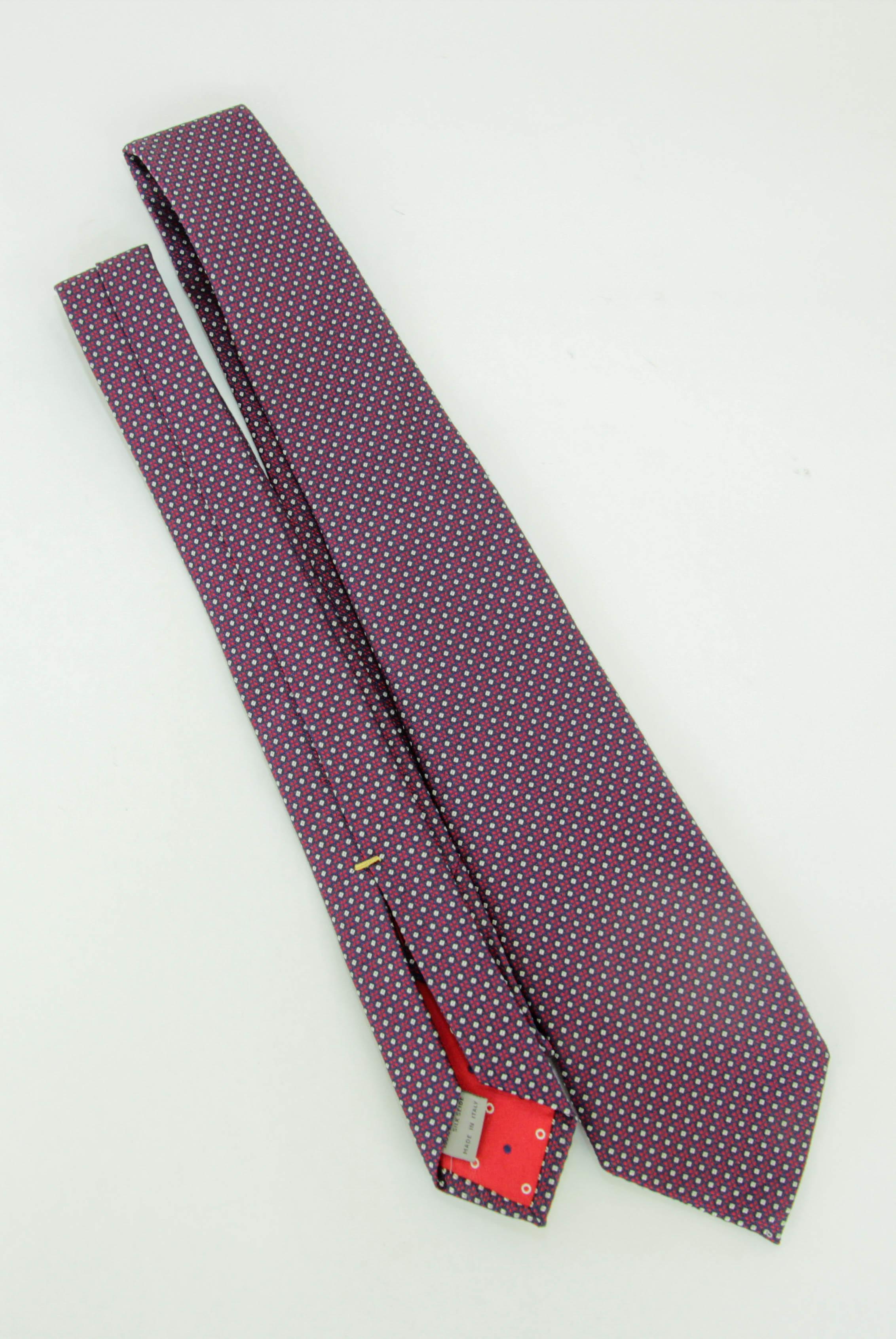 Canali geometric-patterned tie.
Colors are dark red white and blue
Self-tie fastening pointed tip adjustable fit
Silk 100% Dry Clean Only.
Made in Italy.
Width: 3.25 inches.
Elevate your suit with the ultimate finishing touch: a tie that perfectly