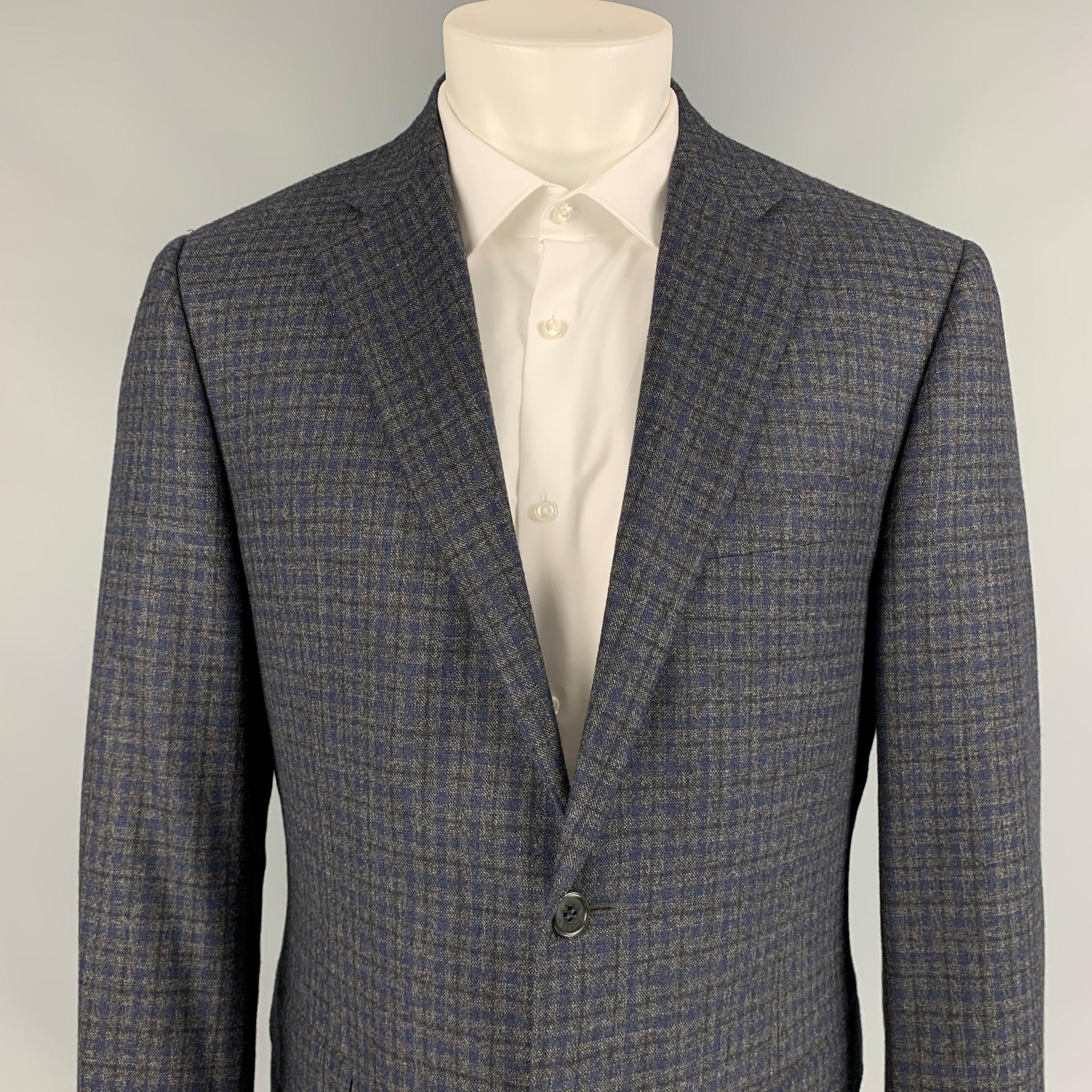 CANALI sport coat comes in a grey & navy plaid wool with a full liner featuring a notch lapel, flap pockets, double back vent, and a double button closure. Made in Italy. 

Very Good Pre-Owned Condition.
Marked: 50 R

Measurements:

Shoulder: 19