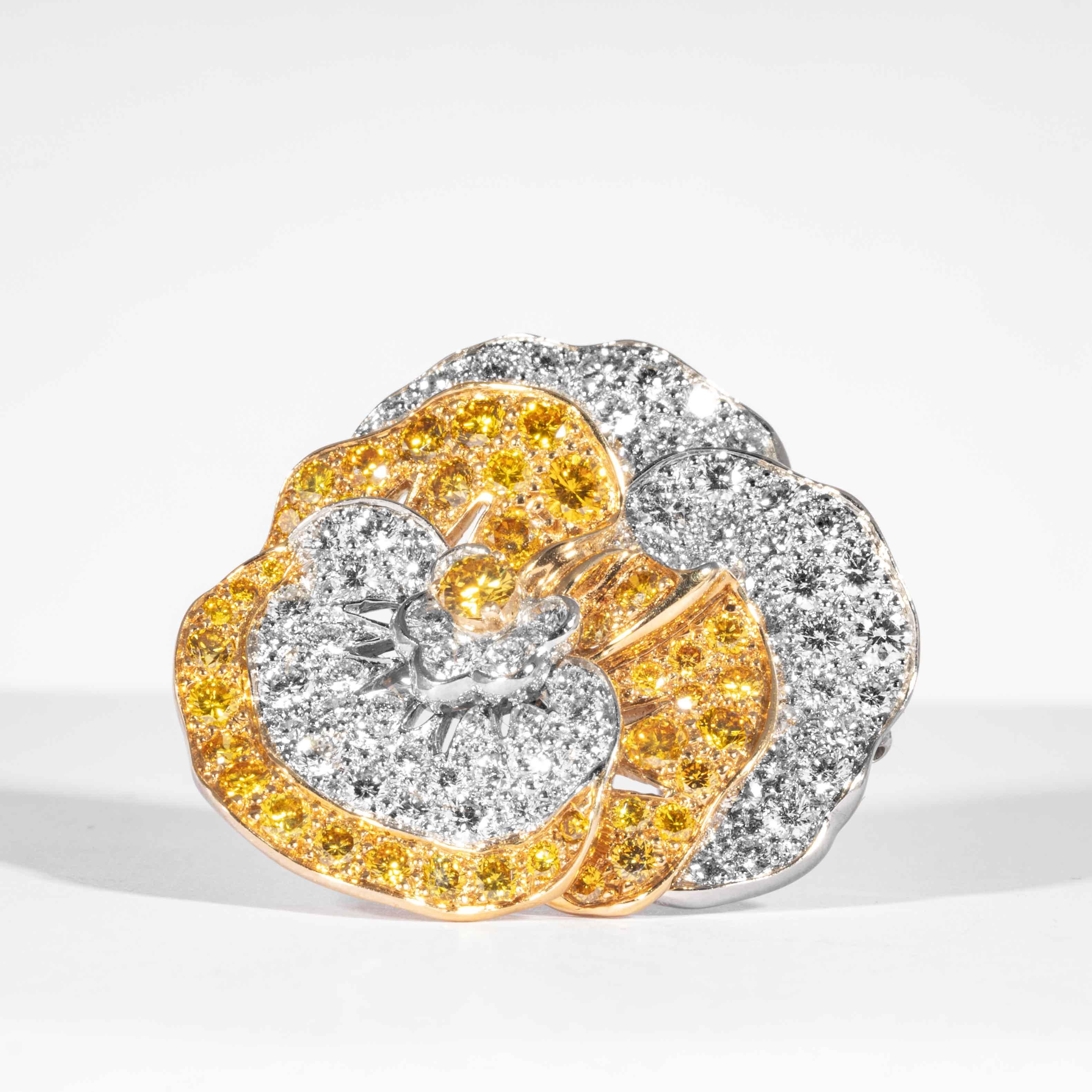 Fancy yellow canary diamonds and white diamonds are set in 18kt yellow gold and platinum in this whimsically classic floral pansy pin. Consisting of approximately 117 round brilliant cut natural canary and colorless white diamonds at a total carat