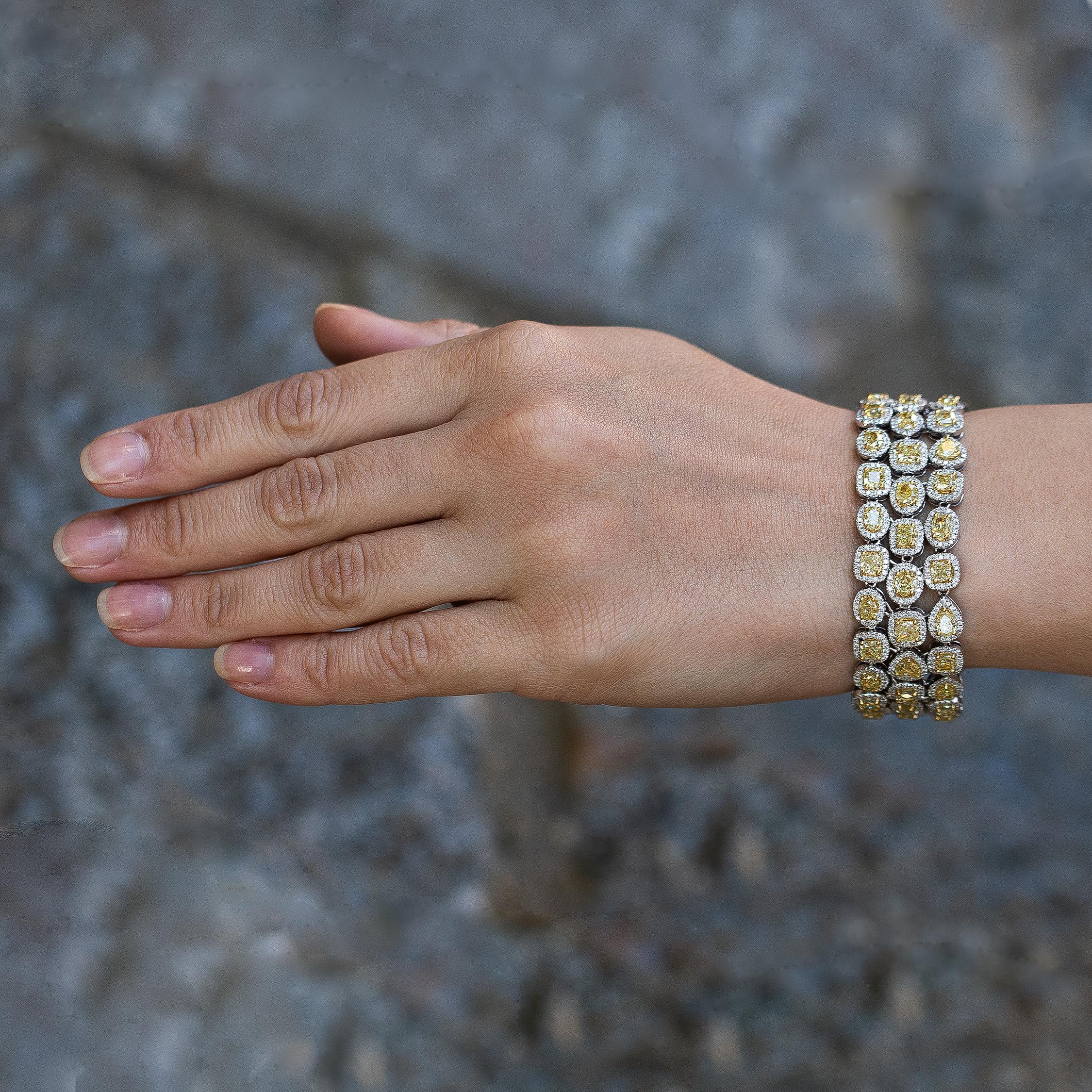 This Stunning Canary Diamond Bracelet is Elegant and Gorgeous.
It is always going to be the centerpiece of any outfit, both casual and formal. 
Canary Diamonds = 23.33 carats
Other Diamonds = 5 carats
( Color: F, Clarity: VS )
1,323 Diamonds
18K