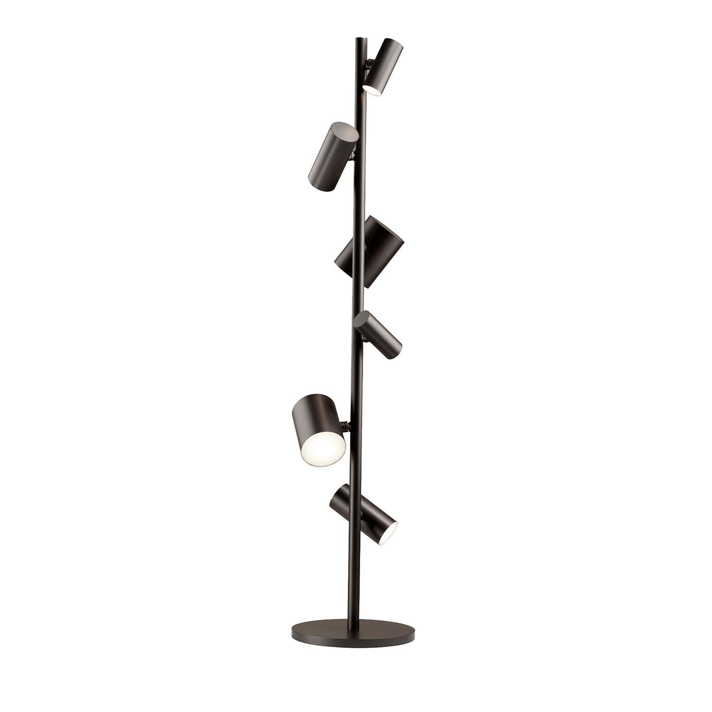 Ideal for accenting professional or residential contexts with ease, this floor lamp by Johanna Grawunder is comprised of spotlights arranged around a central, utterly minimalist shaft stemming from a round base. Its silhouette is fashioned of metal