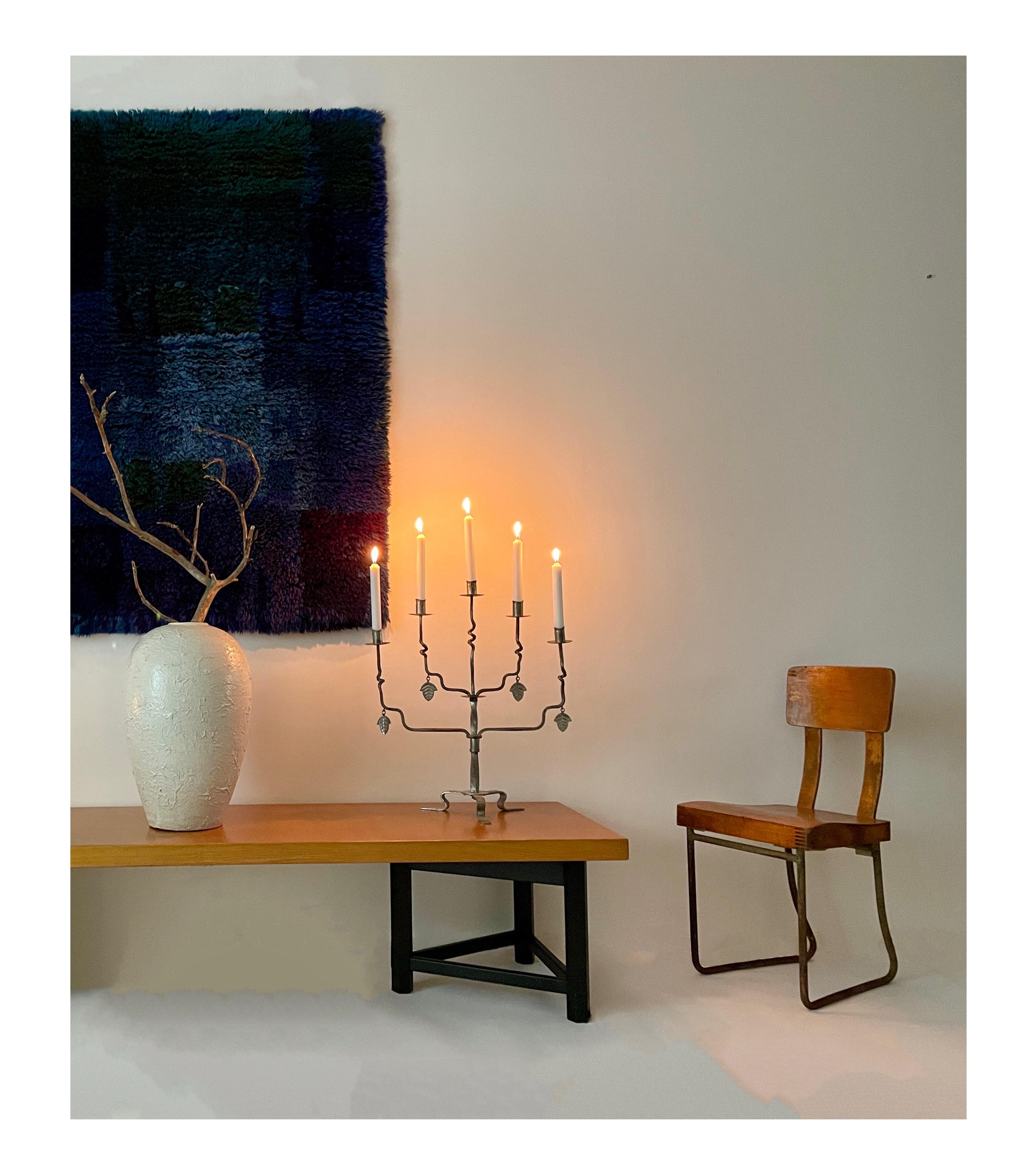 The Hilding Ekelund Candelabra (documented) is a harmonious blend of artistry and functionality. Crafted from exquisite metal and produced by Taidetakomo Hakkarainen, this piece boasts delicate metal leaves that impart a touch of sophistication to