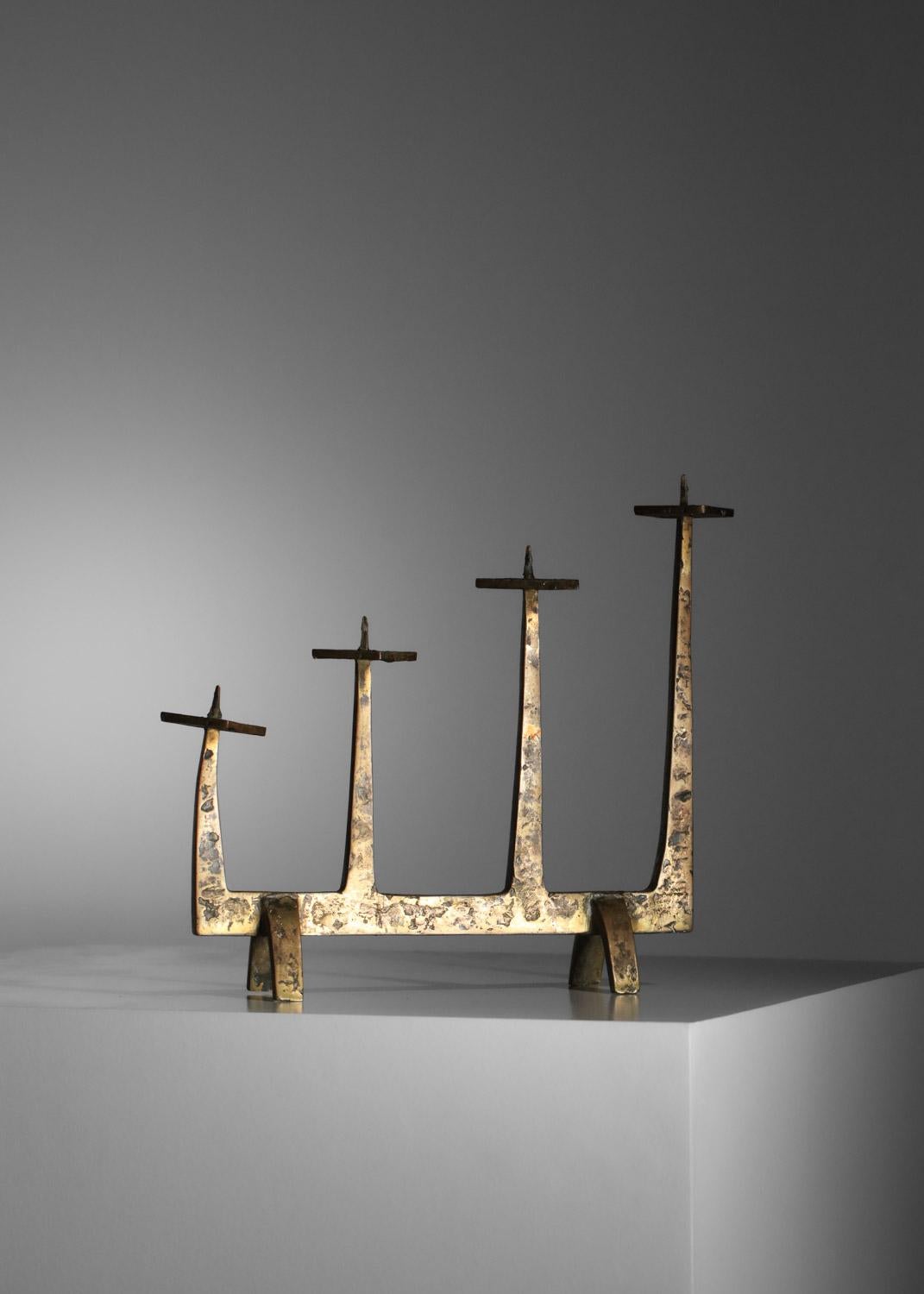 Solid bronze candelabra or candlestick from the 60's in the style of Felix Agostini's work. Brutalized four-branch candlestick in hammered bronze. Beautiful vintage look, with a very nice patina (see photos). 