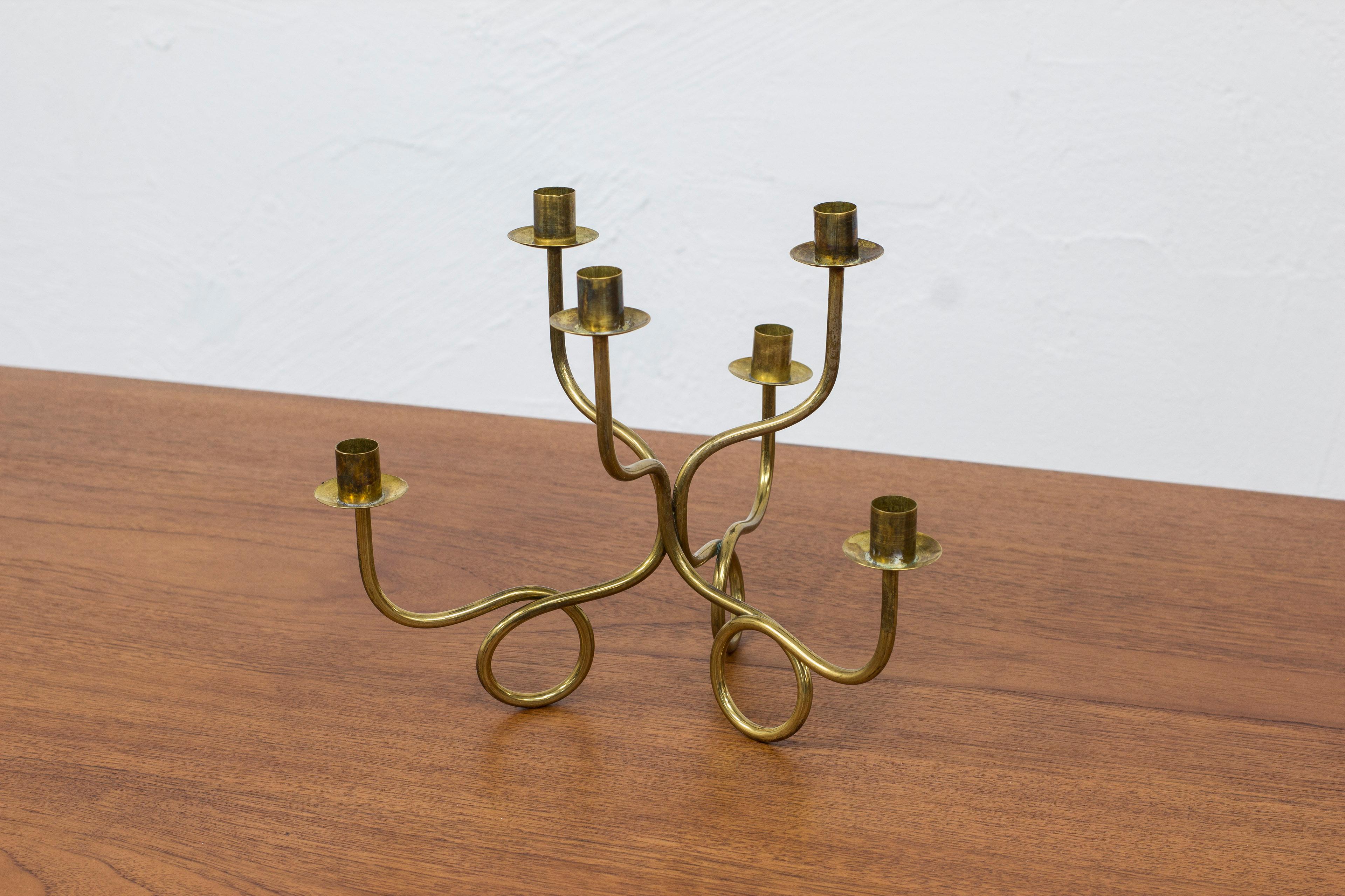 Candelabra designed by Josef Frank. Manufactured by Svenskt Tenn in Sweden. This example ca 1940-50s. Made from solid brass with six candle holders. Very good vintage condition with few signs of age related wear and patina, mainly oxidation to the