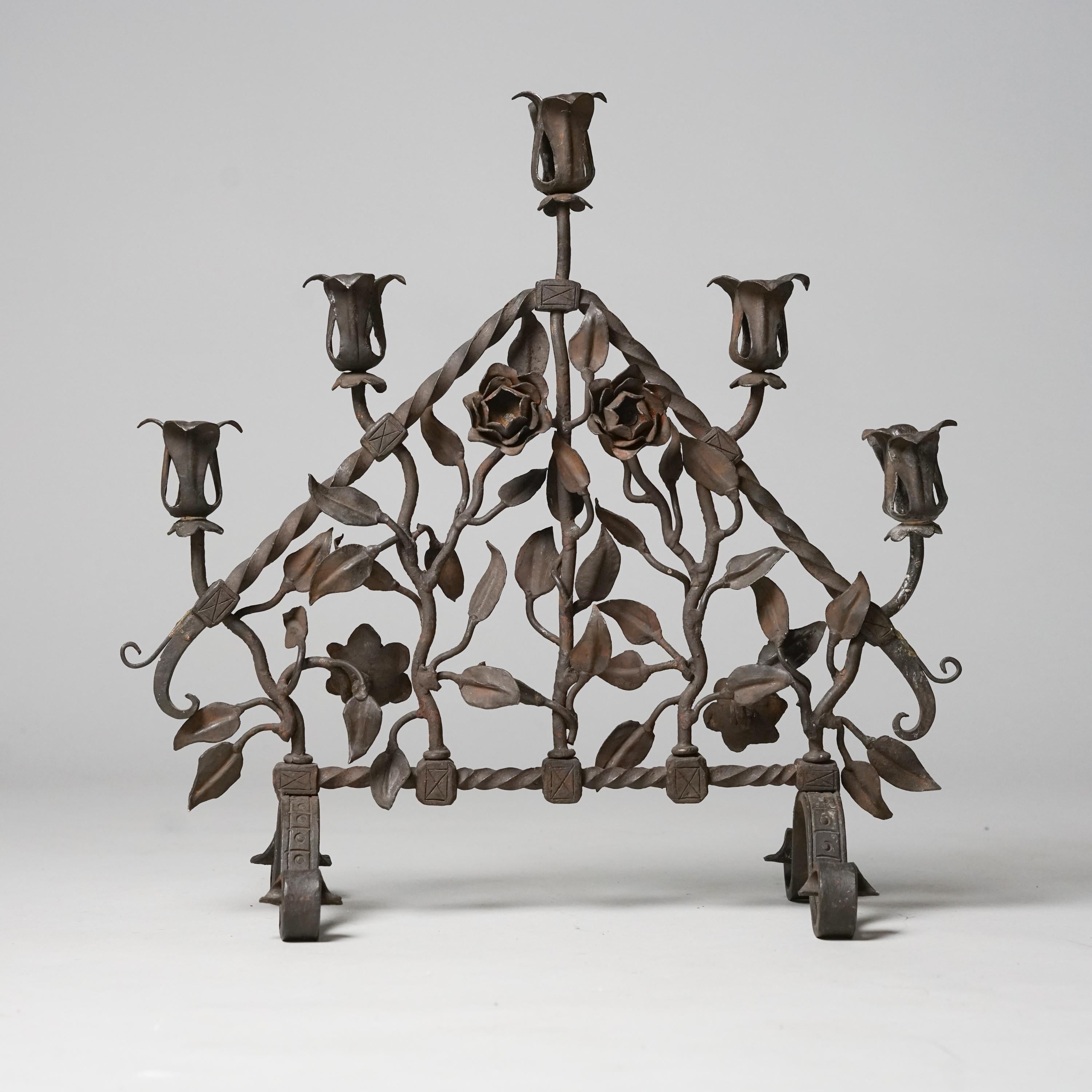 Candelabra, manufactured by Taidetakomo Hakkarainen, Finland, Early 20th Century. Forged iron. Beautiful rose details. Good vintage condition, patina consistent with age and use. 
