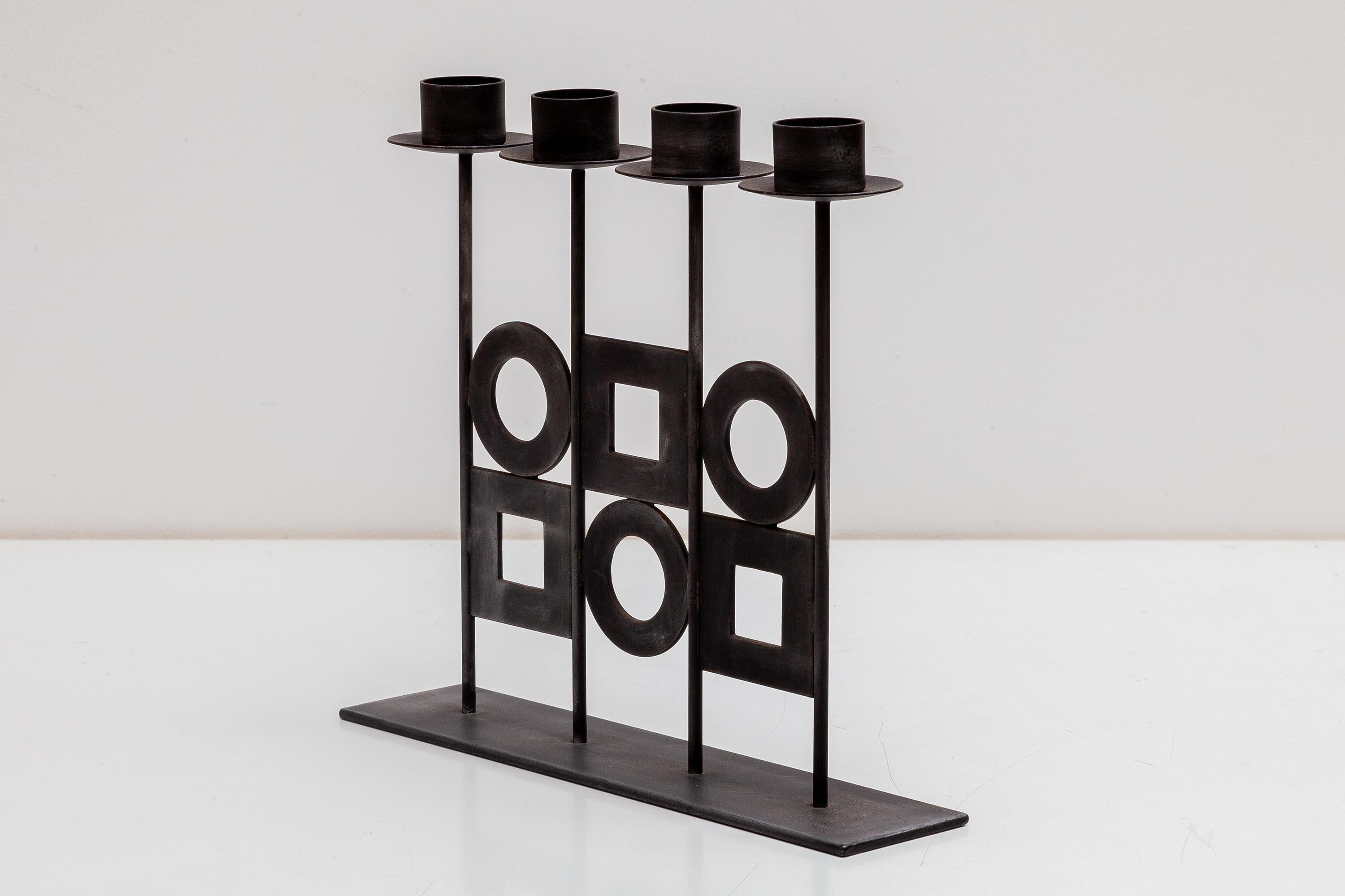 Vintage modernist candelabra, 1960s. Geometric iron and metal work. Holds 4 candles. Dimensions: 26W x 23H x 6D cm.Labeled Made in Austria.