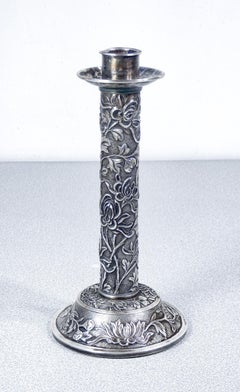 Embossed silver candlestick with vegetal and floral decoration. China, 19th century