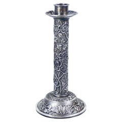 Embossed silver candlestick with vegetal and floral decoration. China, 19th century