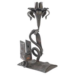 Wrought iron candle holder with snake and flower and match holder